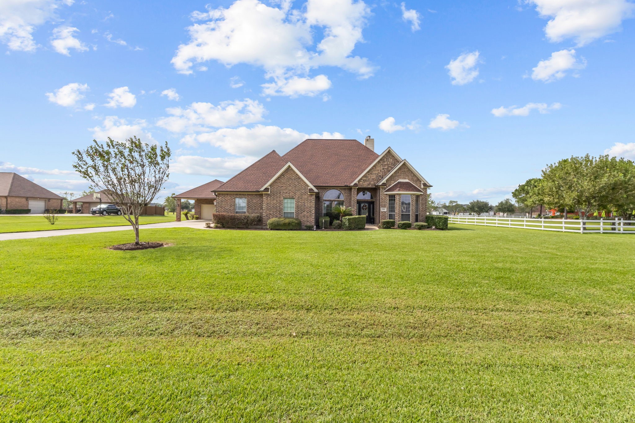 Enjoy the open, spacious setting of this property, featuring a generous front yard.The wide driveway provides convenient access to the home and detached garage.