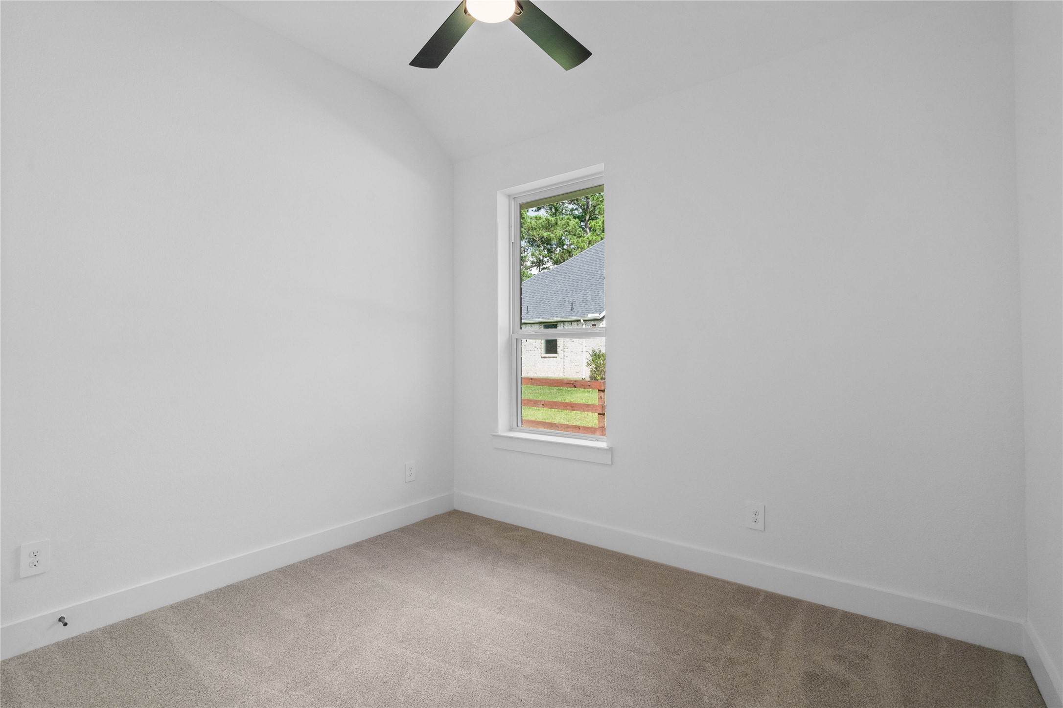 This versatile secondary bedroom offers a bright, neutral canvas with plush carpet flooring and light walls, creating a welcoming and adaptable space for guests, a home office, or a growing family.