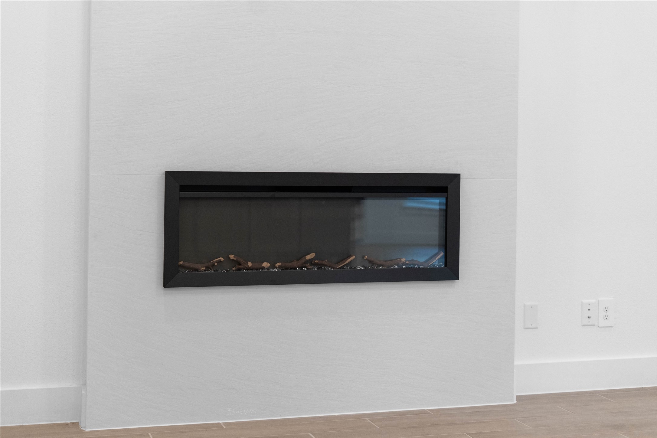 A sleek, modern electric fireplace serves as a stunning focal point, blending seamless architectural design with instant cozy ambiance.
