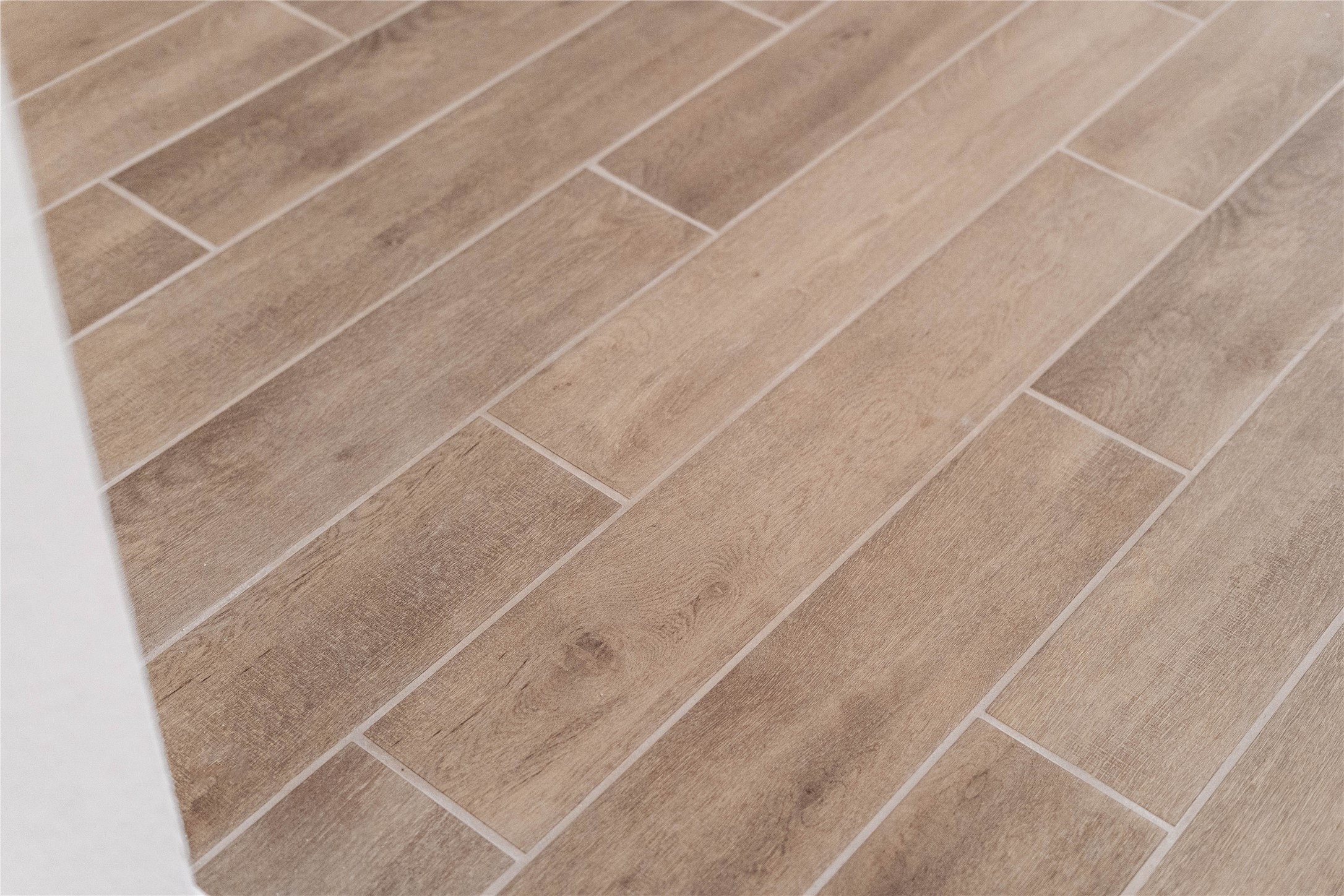 Premium wood-look tile flooring offers the organic warmth and beauty of natural hardwood combined with the unmatched durability of tile.