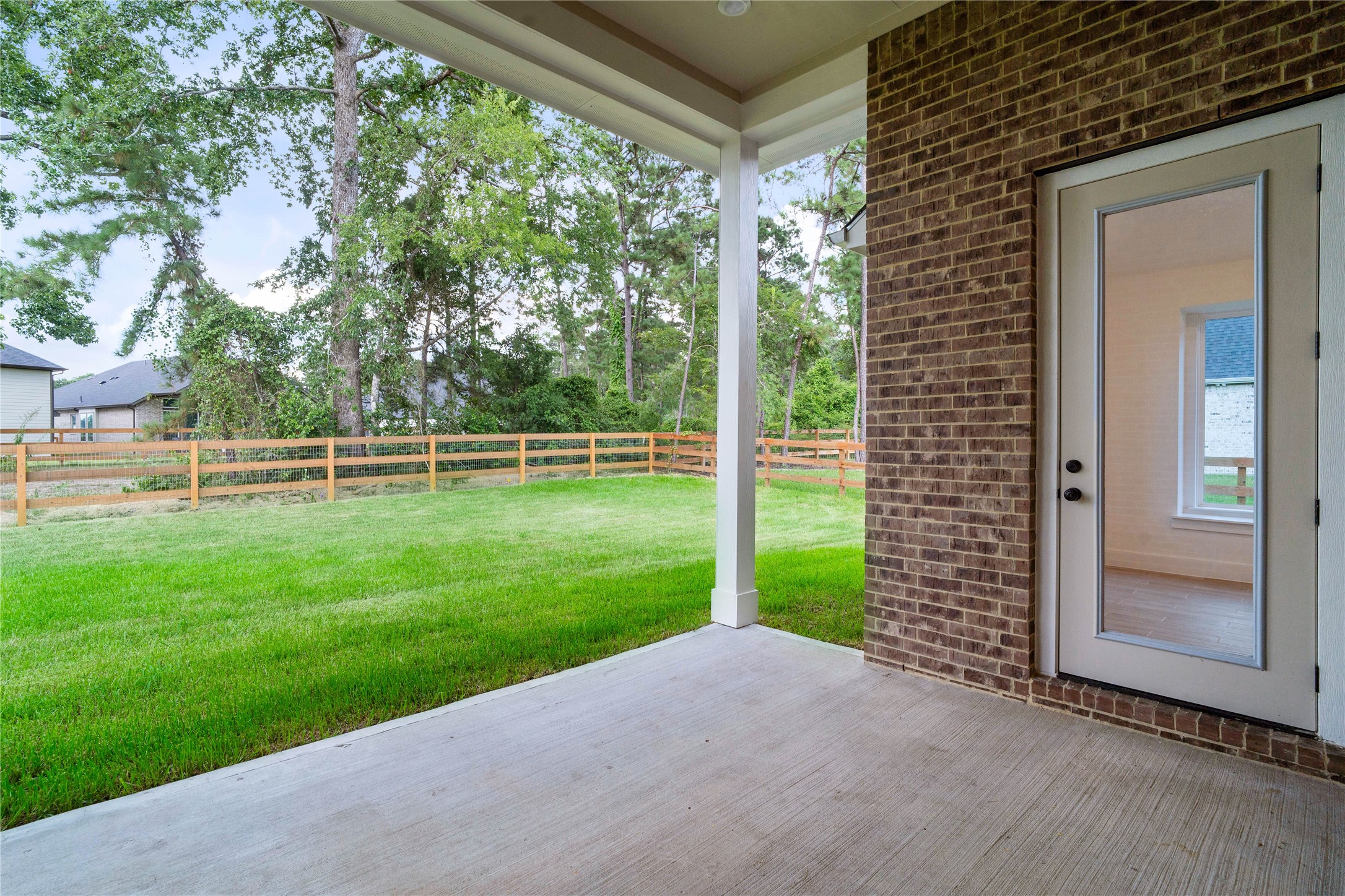 An expansive covered back covered patio seamlessly extends the home's living space outdoors, offering a perfect setting for open-air relaxation or dining.