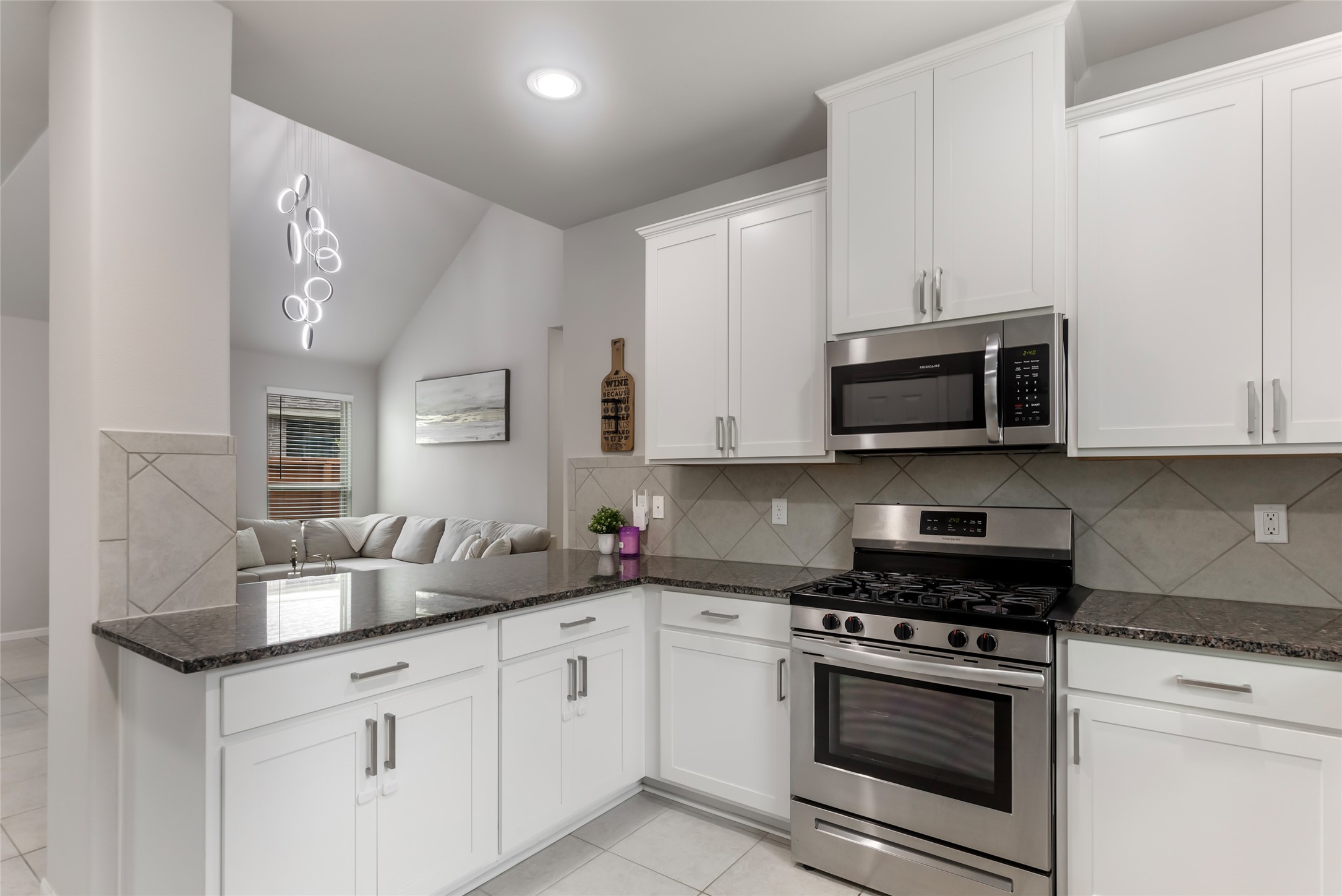 Open kitchen offers plenty of cabinet storage and countertop workspace while remaining connected to the main living areas.