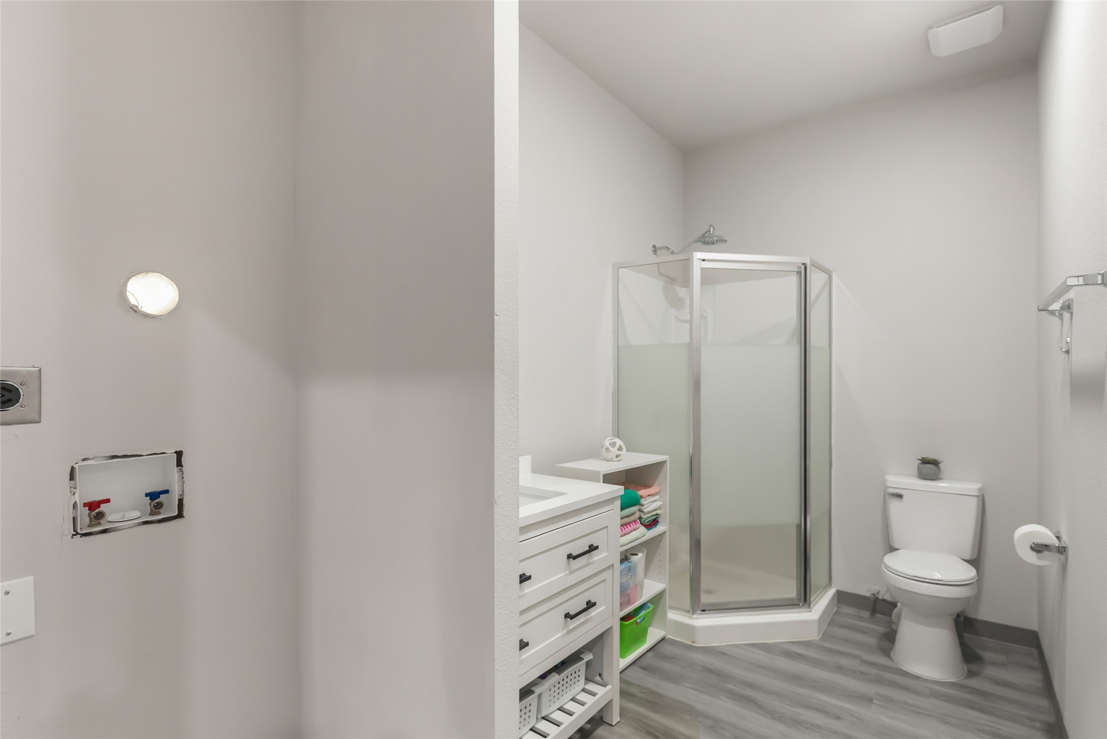 Full bathroom serves the converted garage living area and adds even more flexibility. Notice the washer/dryer hooks ups ready for a dedicated (stackable) laundry.