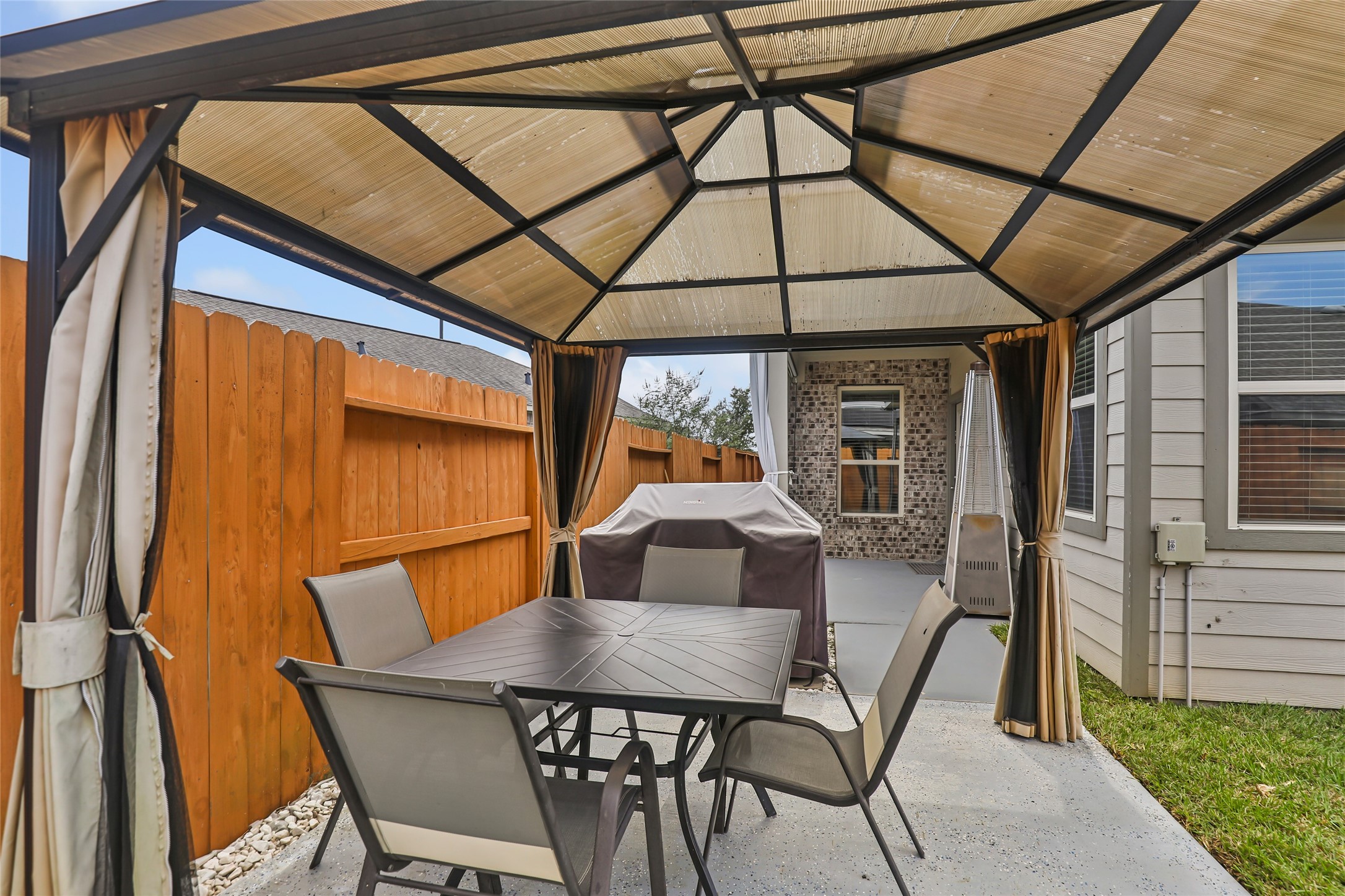 Enjoy outdoor dining or relaxing under the covered patio in the privacy of the fenced backyard.