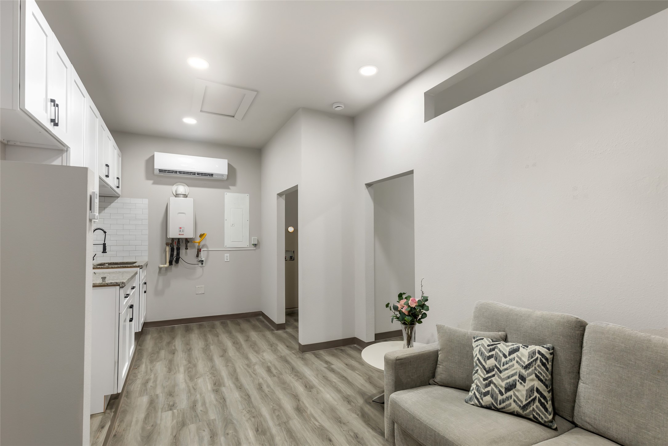 Spacious converted garage offers a versatile living area with kitchenette, flex room/office and full bathideal for guests, multigenerational living, a roommate, office or private retreat.