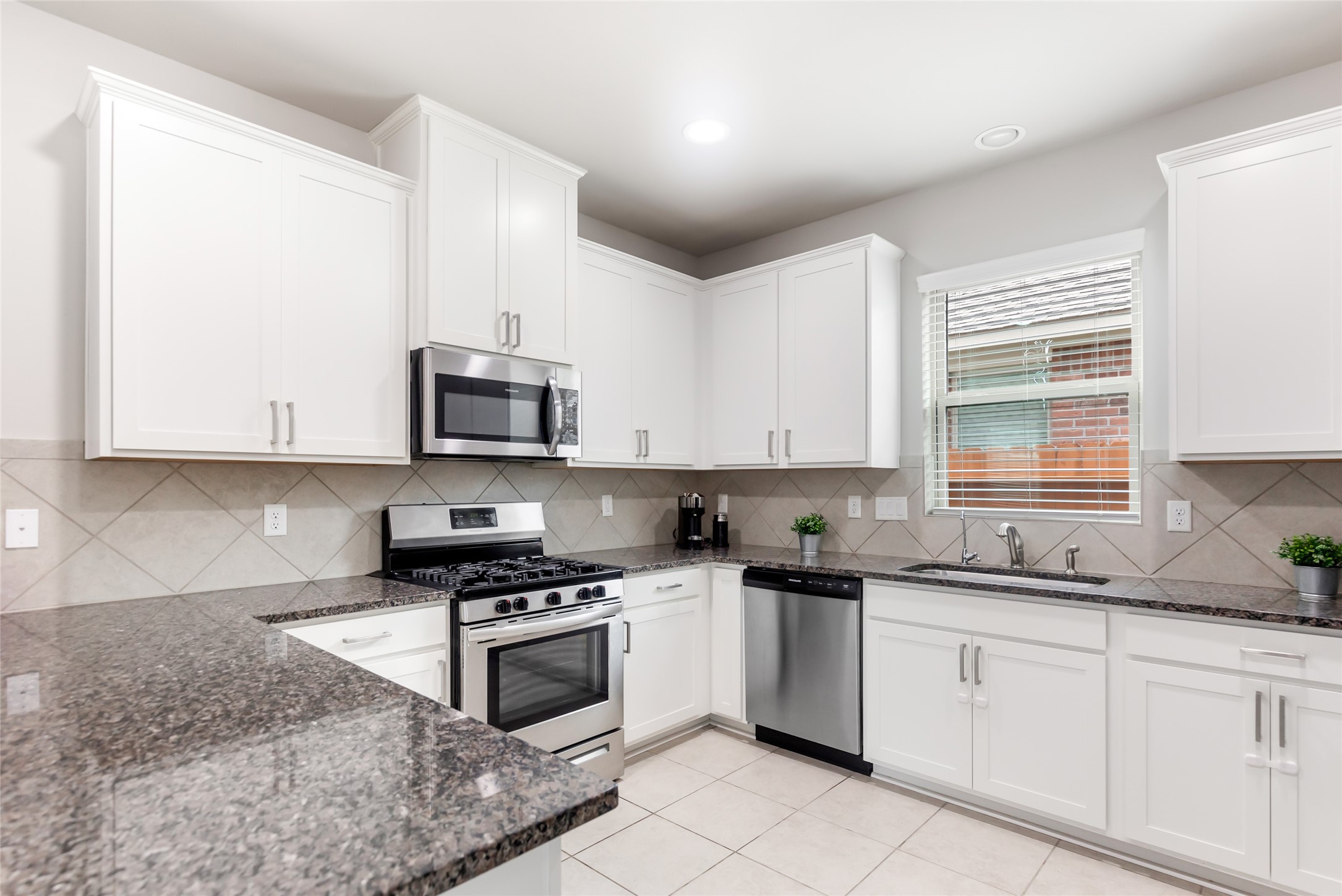 Abundant cabinetry, granite countertops, stainless appliances and a convenient peninsula make this kitchen both attractive and functional.