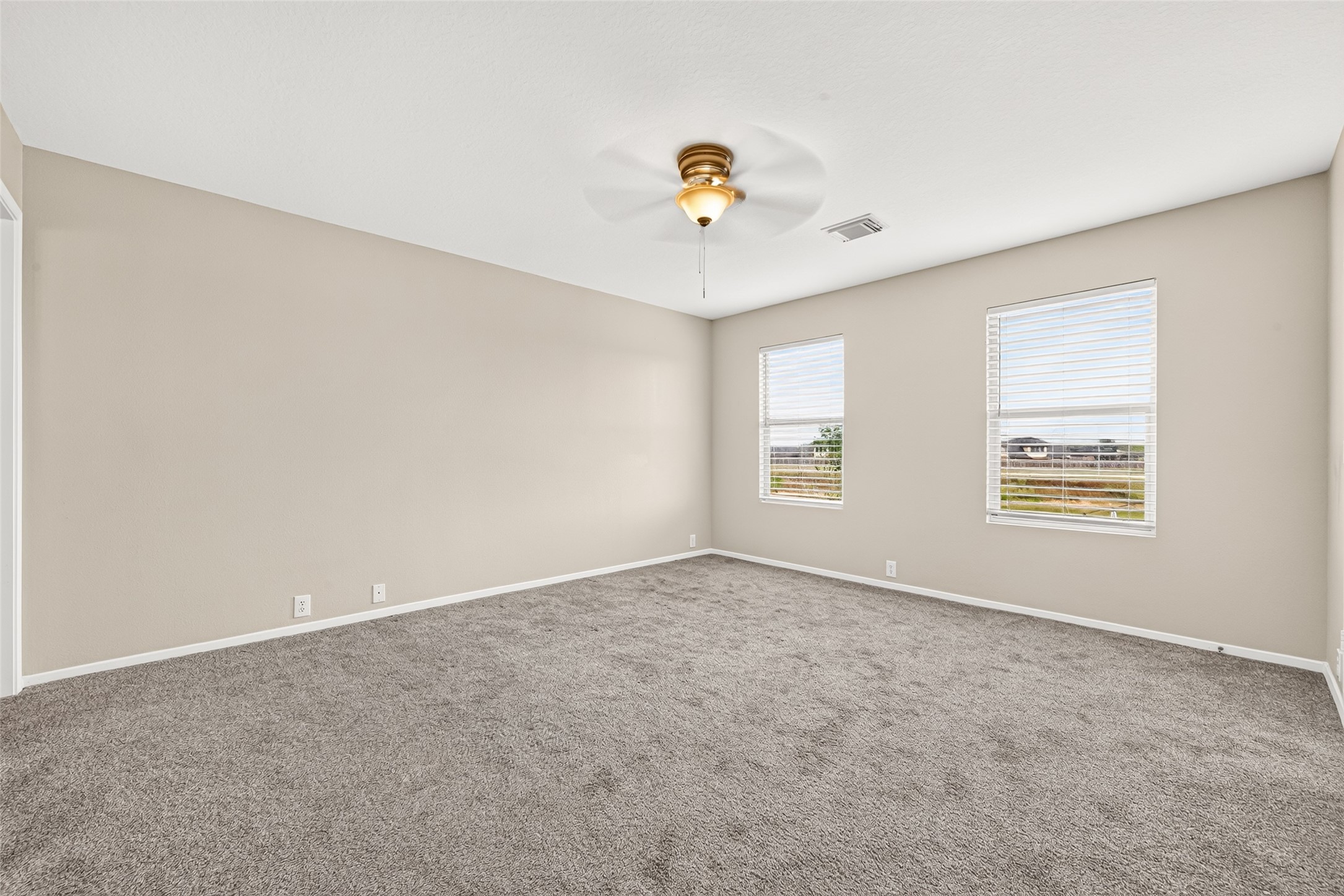 Primary bedroom features lots of natural light and ample space
