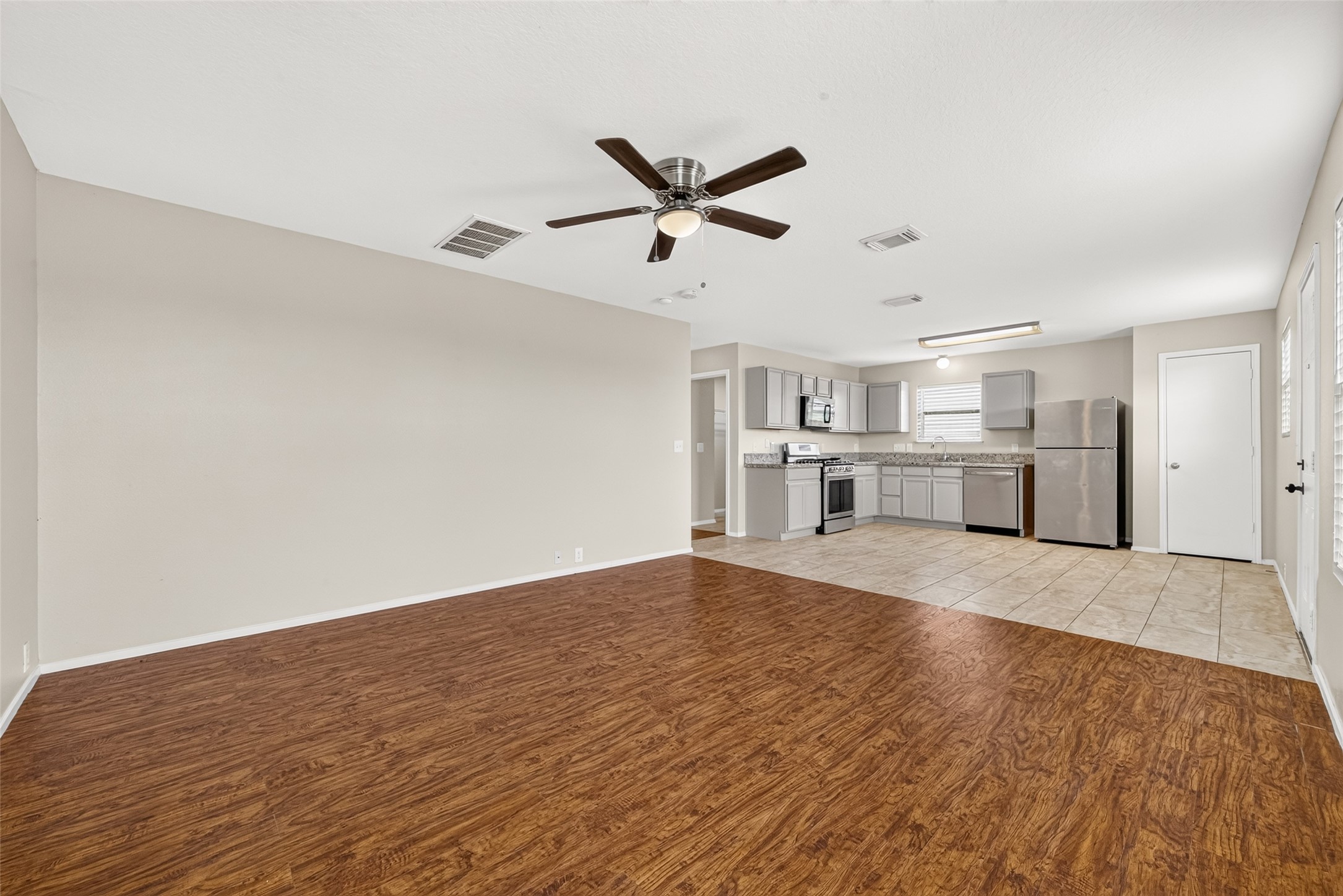 Spacious second living room featuring an open-concept layout that flows seamlessly into the kitchen and breakfast area