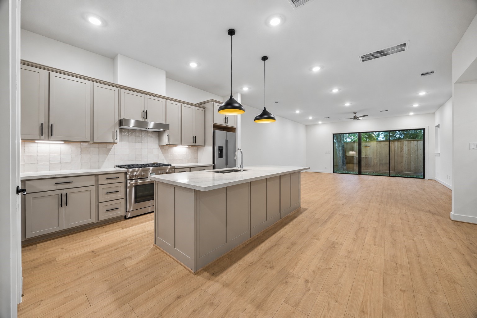 Beautiful open-concept first-floor living featuring a spacious kitchen with an oversized island, modern finishes, and a seamless flow into the dining and living areas. Beautiful open-concept first-floor living featuring a spacious kitchen with an oversized island, modern finishes, and a seamless flow into the dining and living areas.