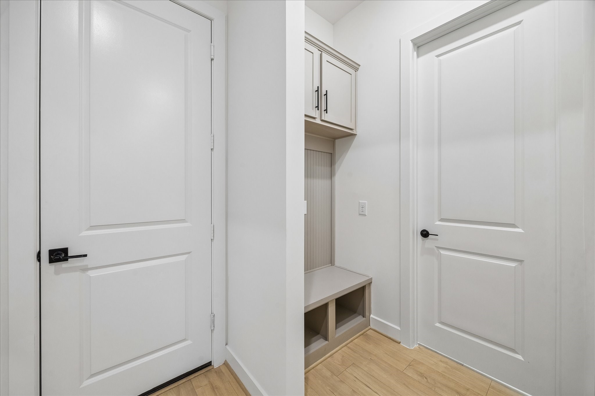 Mudroom by the entrance with built-ins.