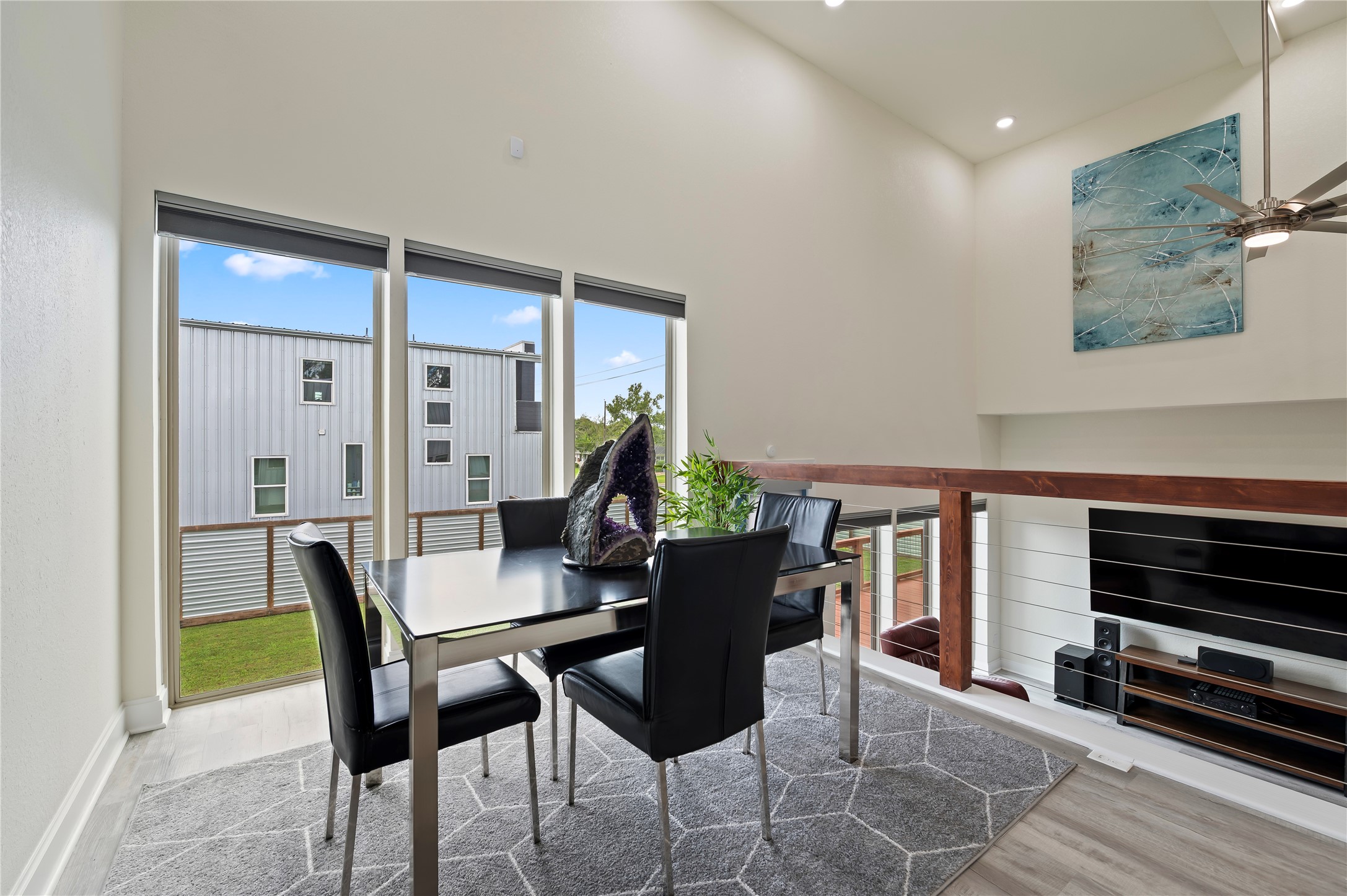 Elevated formal dining area is a versatile flex area and could be used as home-gym or second home-office. This area also features upscale dual directional up/down blinds, lowered from the top and raised from the bottom simultaneously or separately.