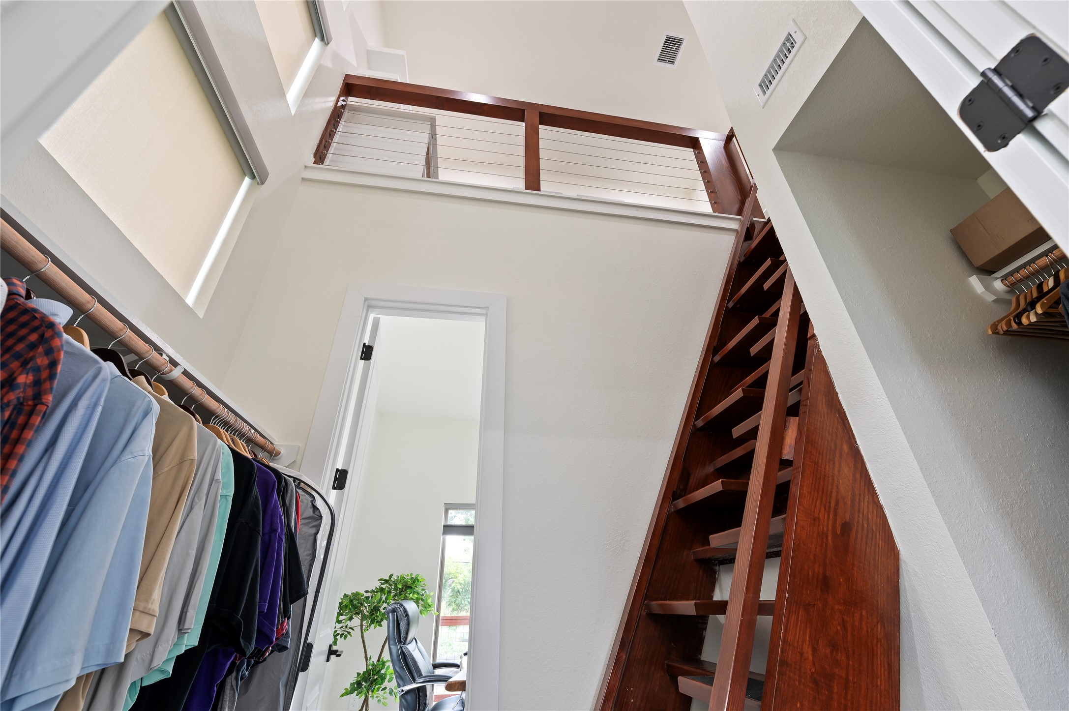Stunning walk-in primary closet with pass through to the study, and Nautical solid oak loft ladder leading to private library.