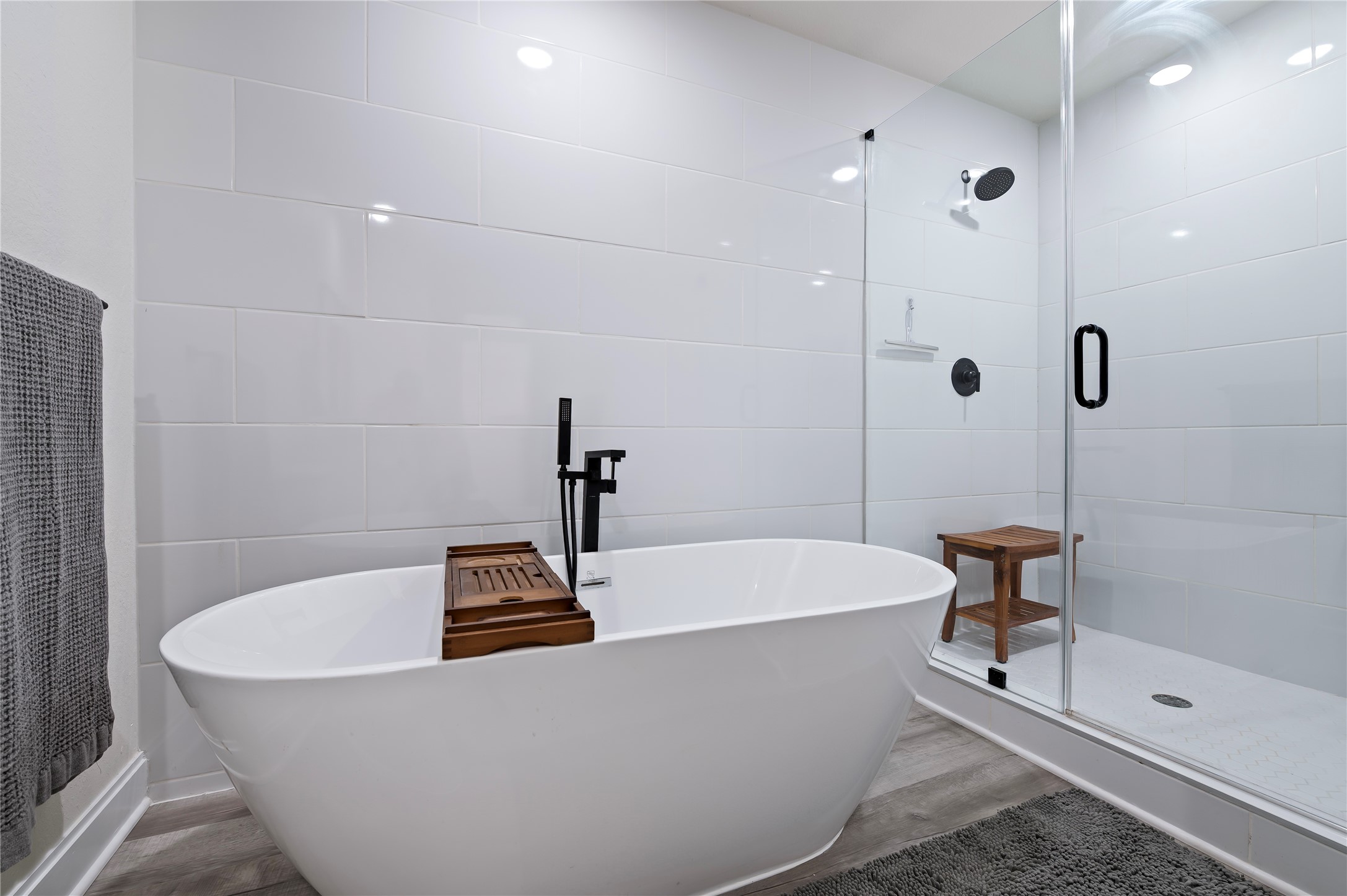 Relax in the large freestanding soaking tub or enjoy the oversized walk-in glass shower with White Porcelain tile surrounding in the upstairs full bathroom.