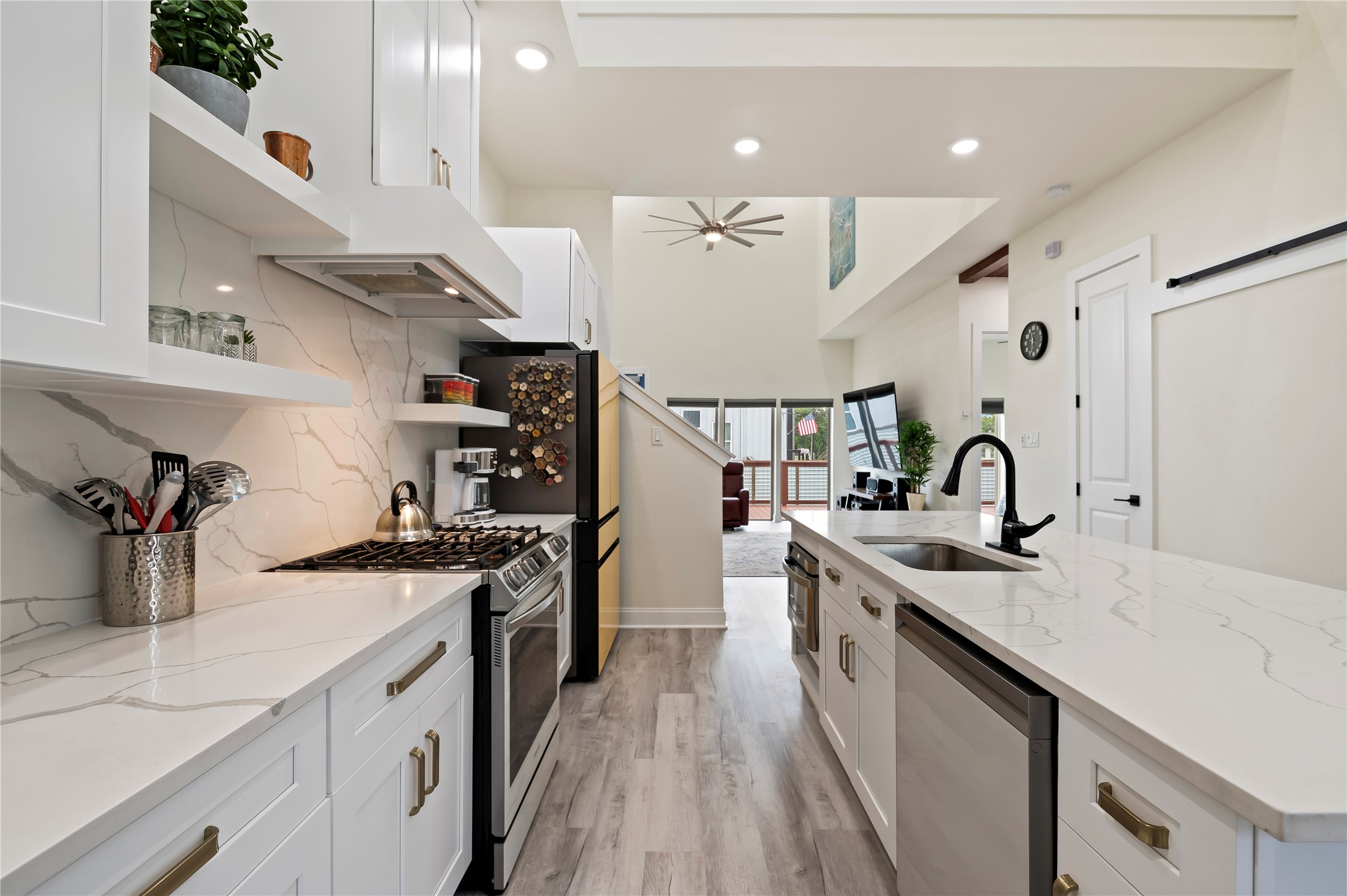 Under-counter auto drawer Stainless Steel Bosch microwave. 100% LED lighting throughout! White Quartz backsplash and countertops with custom hardware on kitchen cabinets and drawers to match.