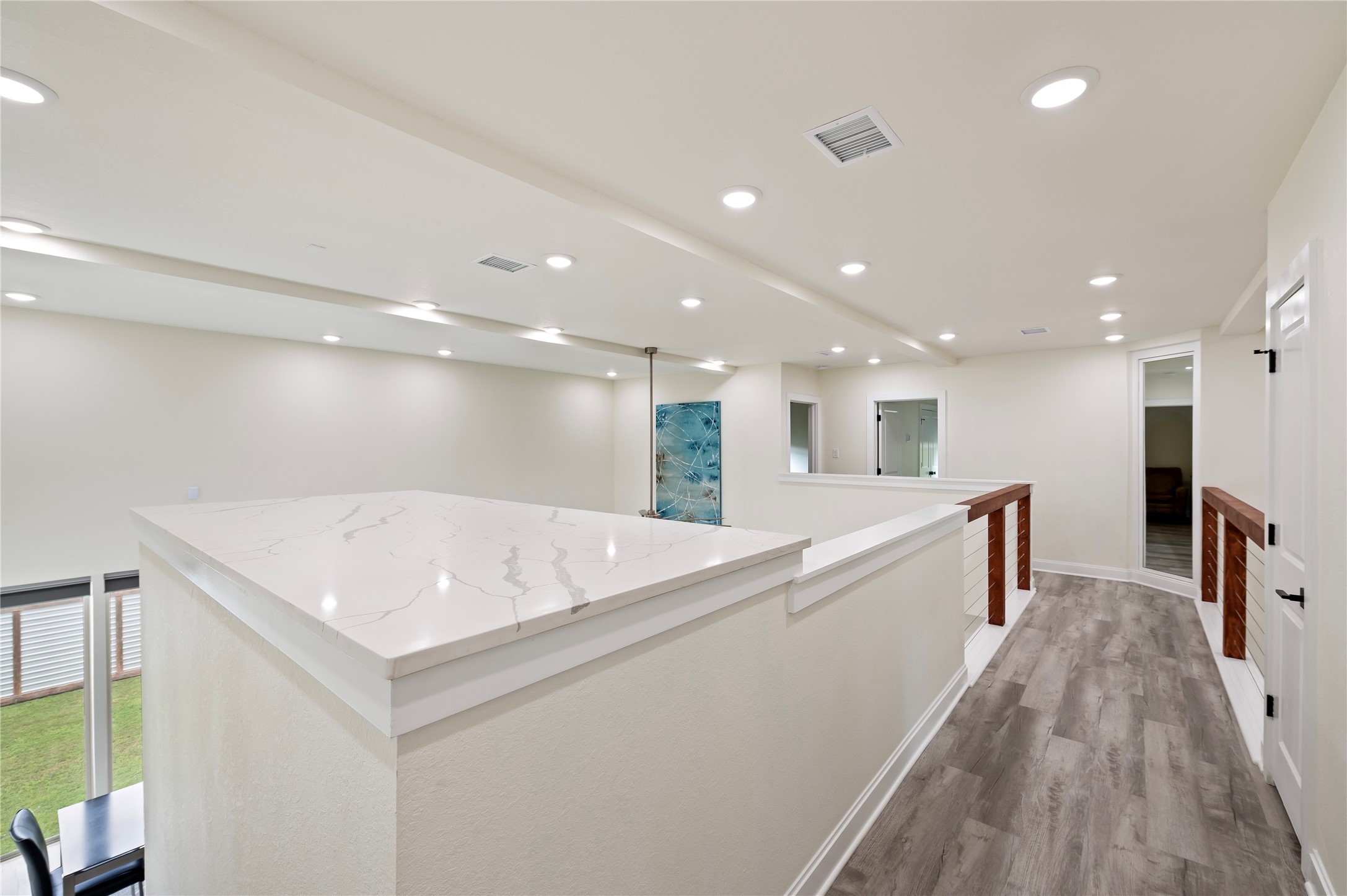 Staircase landing with large Quartz countertop art display area. Large insulated mechanical room at the top of the stairs for convenient HVAC access. Coax, Cat-6 and cable available throughout.