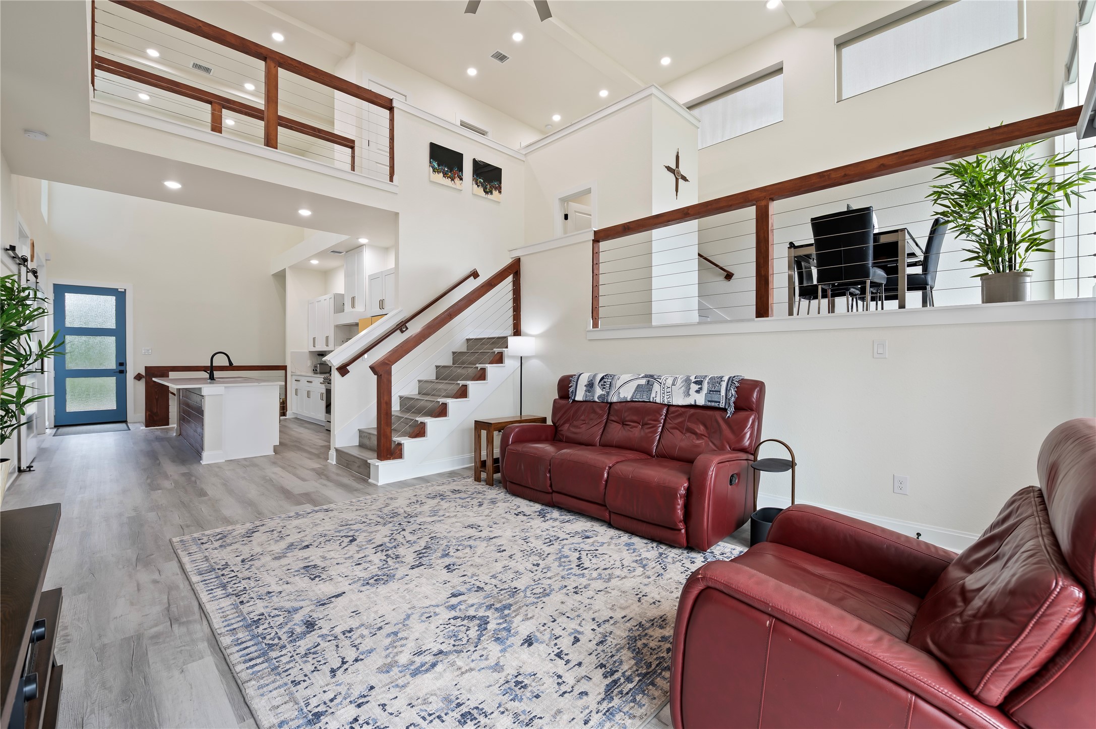 Desirable Rexford Model open concept floor plan with coated horizontal cable stairway and catwalk with cedar railing throughout; upgraded ceiling fan too.
