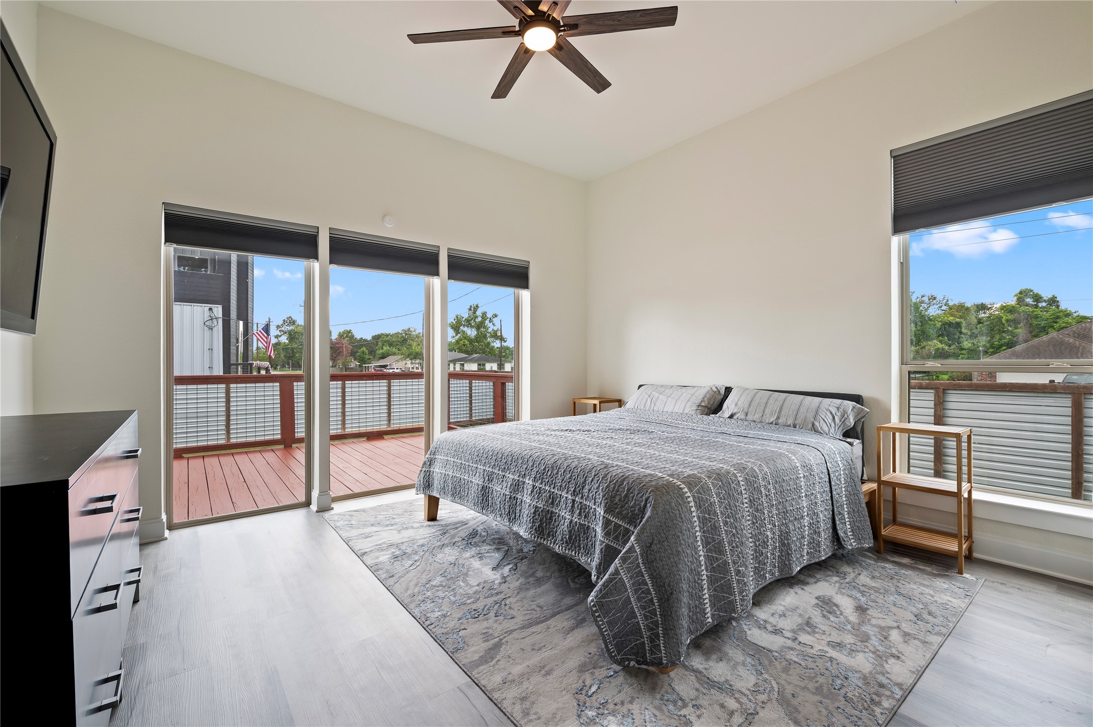 Stunning primary bedroom downstairs with 10' ceilings, COREtec Pro Plus Vinyl Plank flooring in Chesapeake Oak, Sherwin Willams Swiss Coffee paint and dual directional up/down blinds, lowered from the top and raised from the bottom simultaneously or separately.