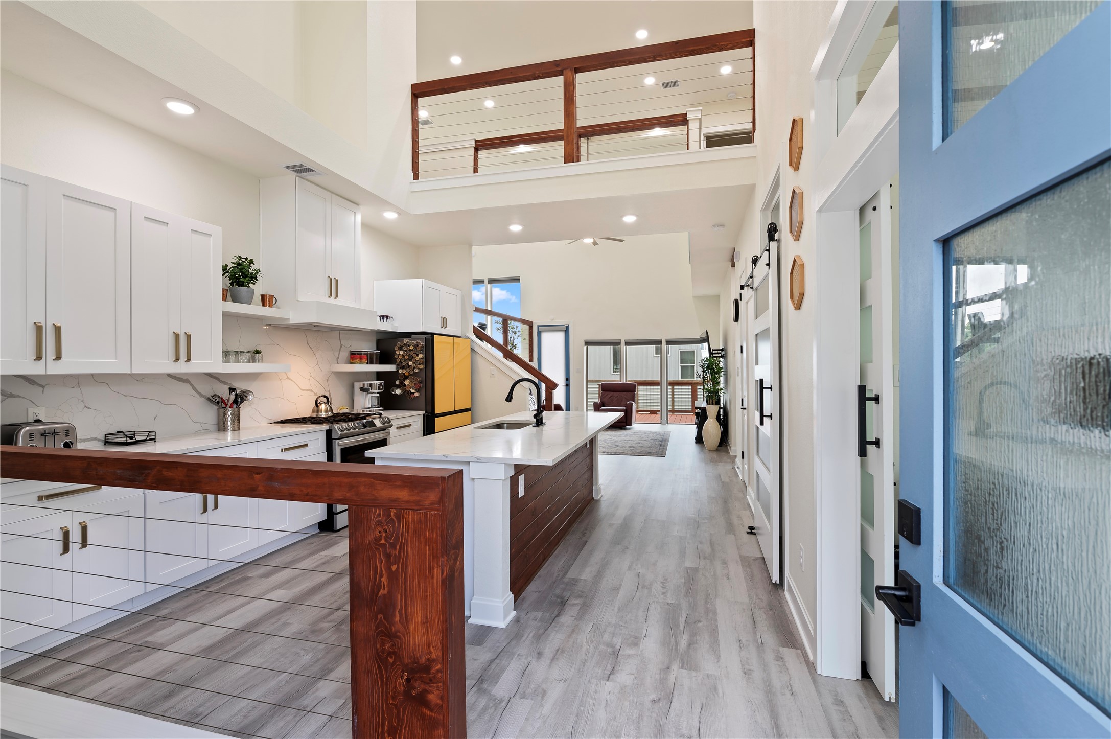 Inviting entrance with 20' ceilings in kitchen, family room and dining area. Coated horizontal cable stairways and catwalk with cedar railing throughout.