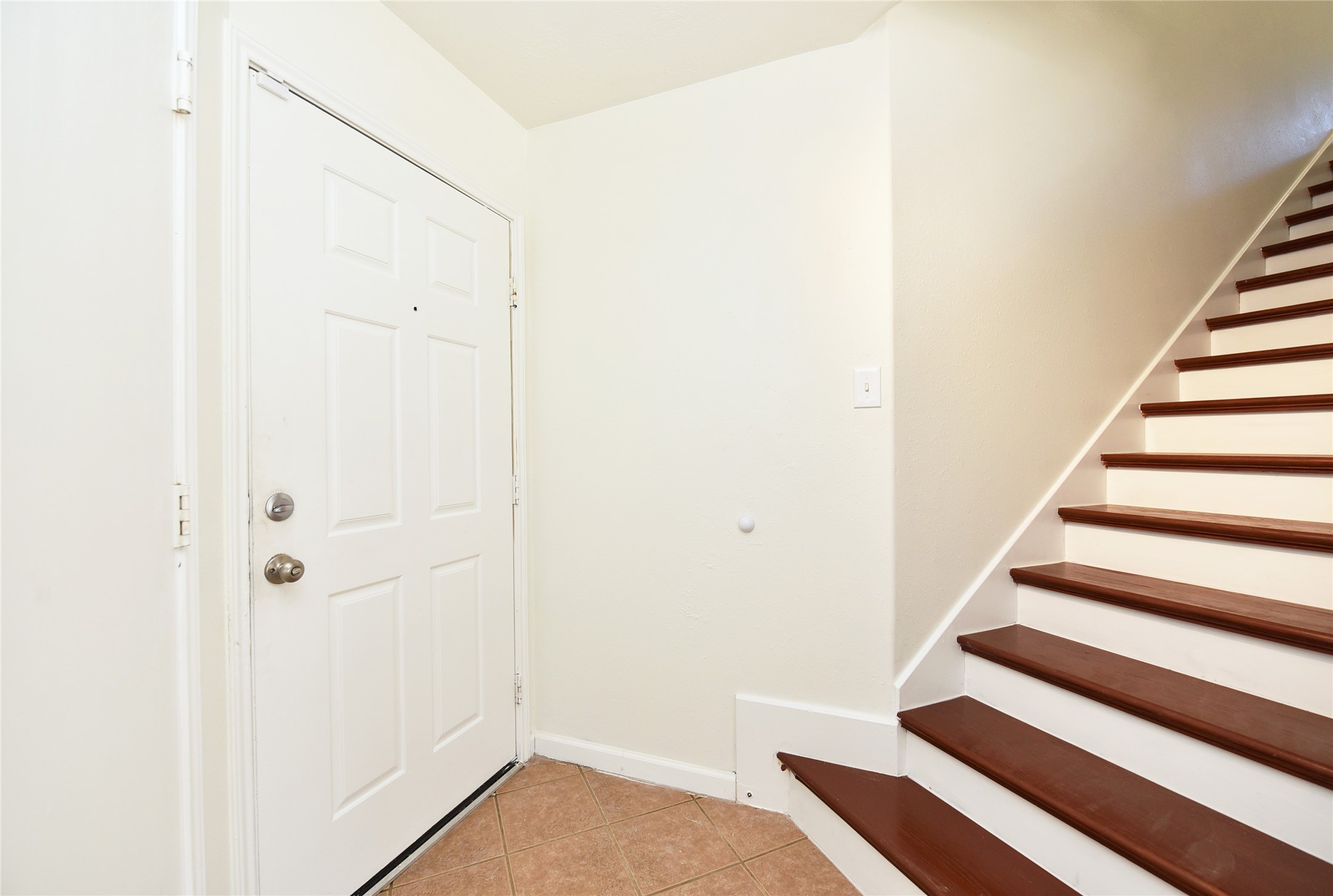 Notice the wood clad stair case. Easy to keep clean. No need to drag a vacuum.