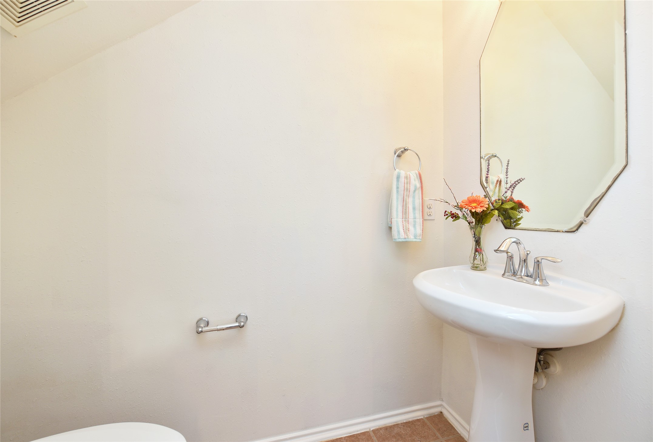 The half bath is conveniently located down stairs for guests.