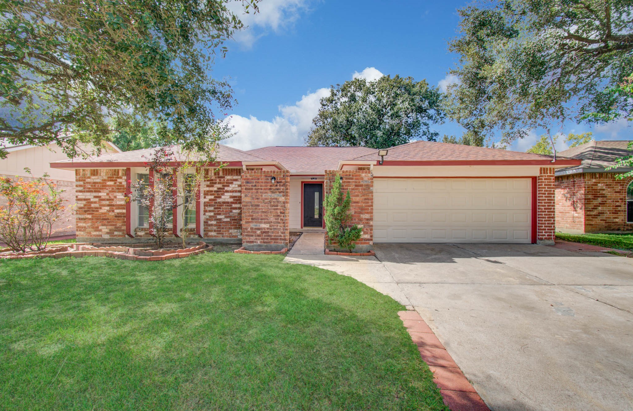 Charming brick home with a spacious two-car garage, nestled on a well-maintained lawn with mature trees providing shade and curb appeal. Charming brick home with a spacious two-car garage, nestled on a well-maintained lawn with mature trees providing shade and curb appeal.