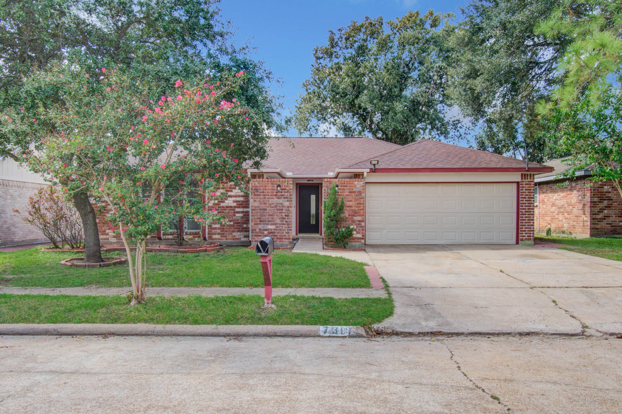 Charming brick home with a spacious two-car garage, surrounded by lush greenery and mature trees, offering excellent curb appeal. Charming brick home with a spacious two-car garage, surrounded by lush greenery and mature trees, offering excellent curb appeal.