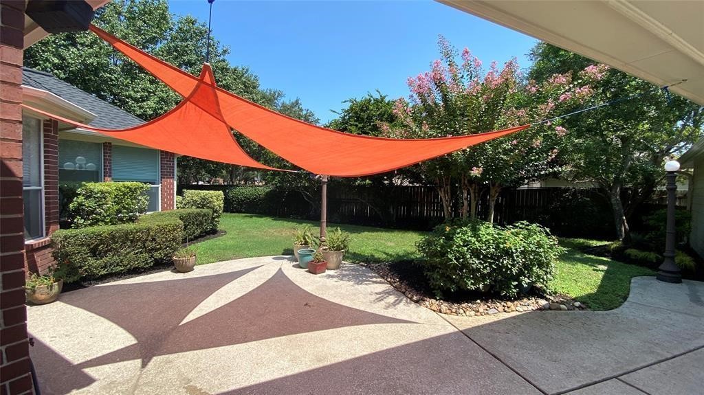 Experience serene outdoor relaxation in the shaded backyard oasis.