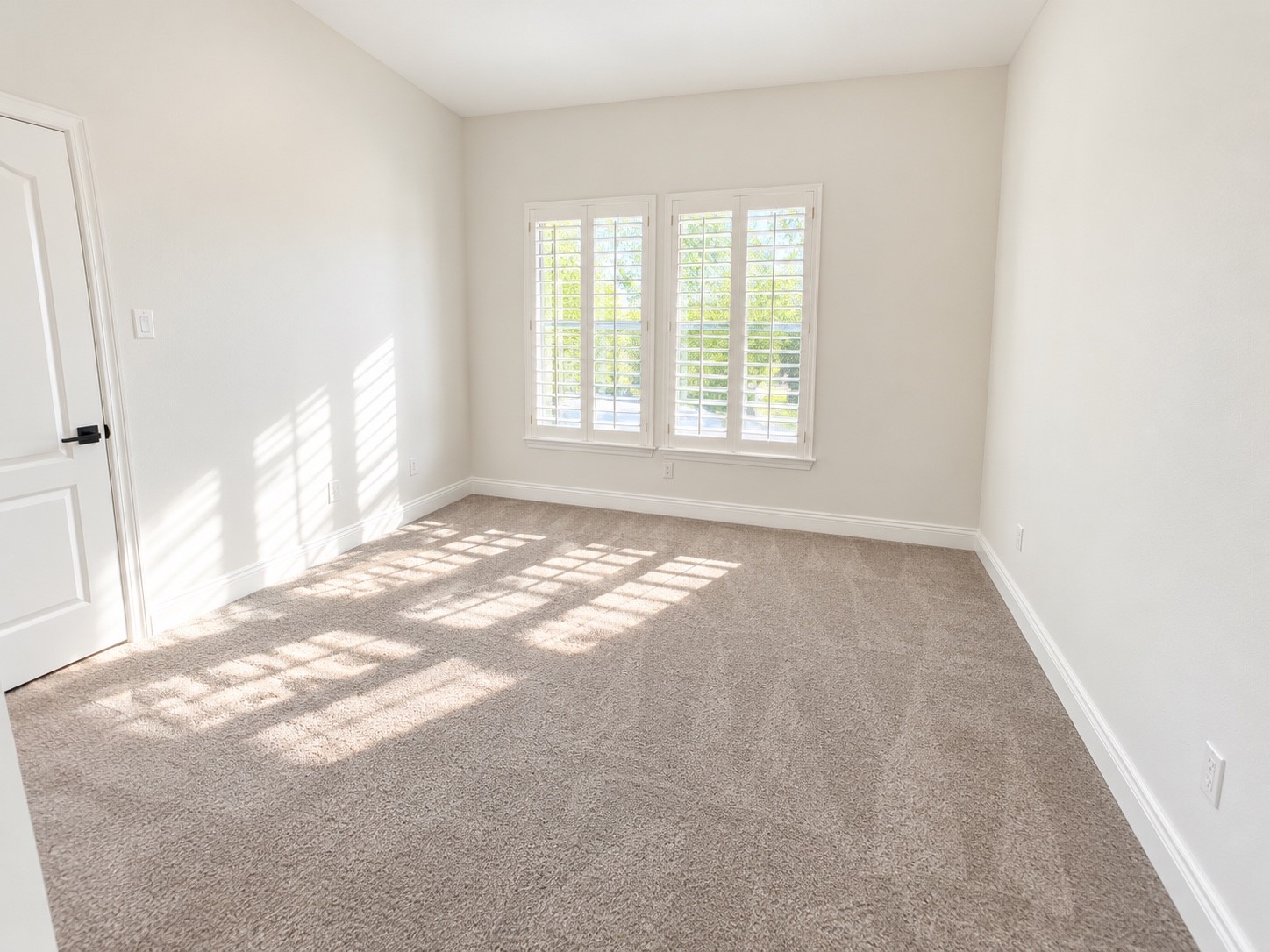 Upstairs features one of the three spacious bedrooms, offering ample natural light and comfort.