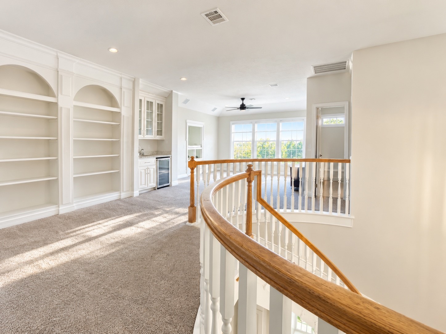 Upstairs game room featuring ample shelving for storage and display.