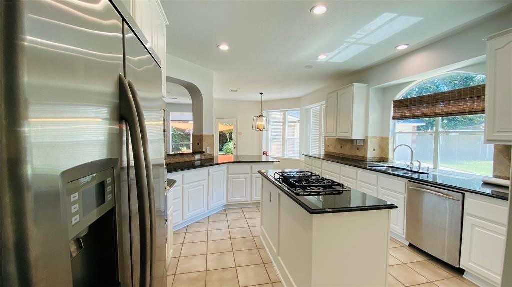 Modern island kitchen with sleek countertops, ample cabinetry, and stainless steel appliancesideal for cooking and entertaining.