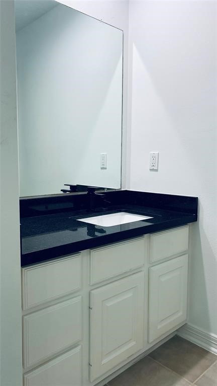 This elegant Jack and Jill bathroom features a sleek black countertop and ample storage, perfect for shared convenience and style.