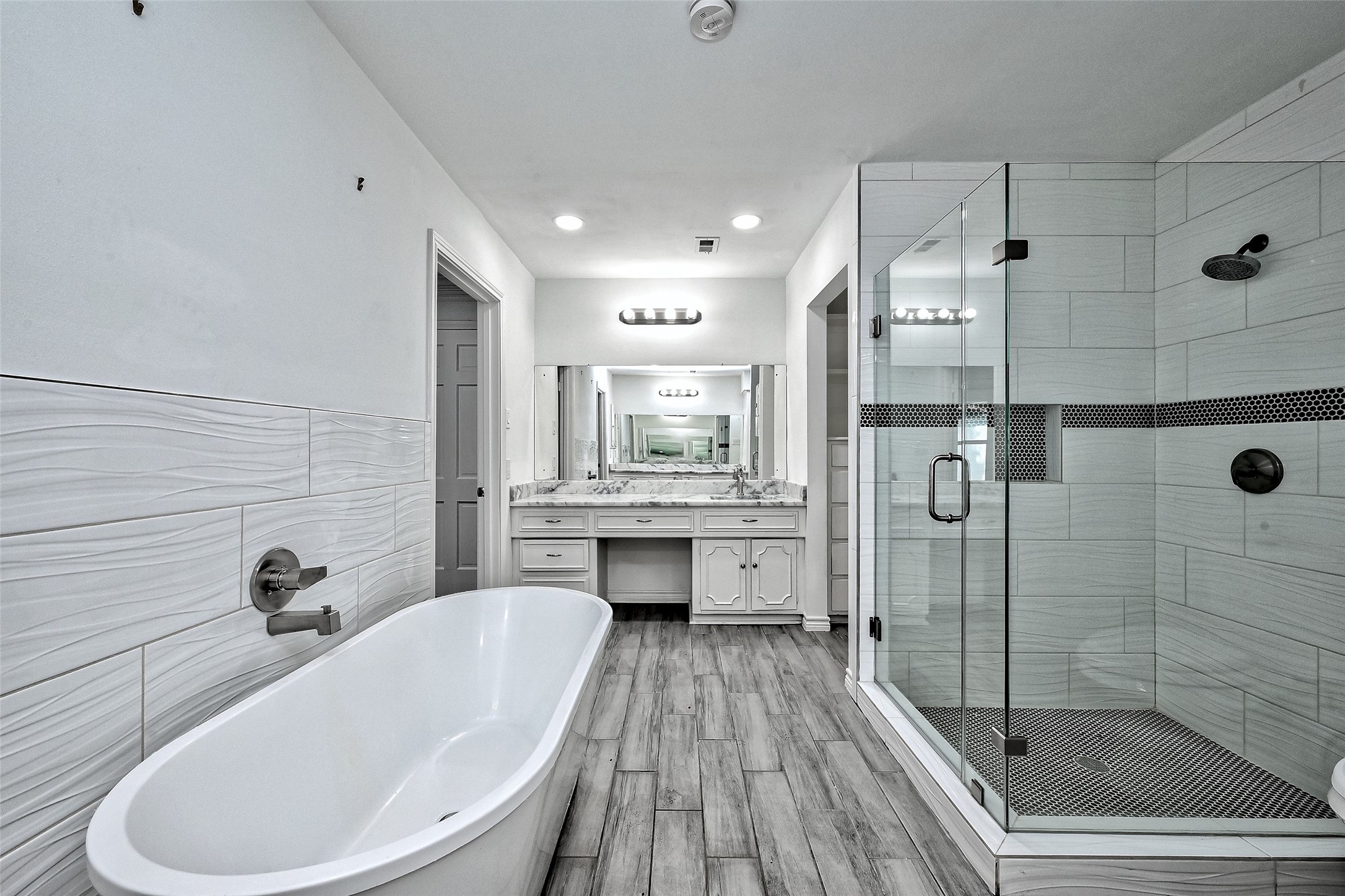 Primary bath with soaking tub, shower room, his & her vanity area, 2 large walk in closets.
