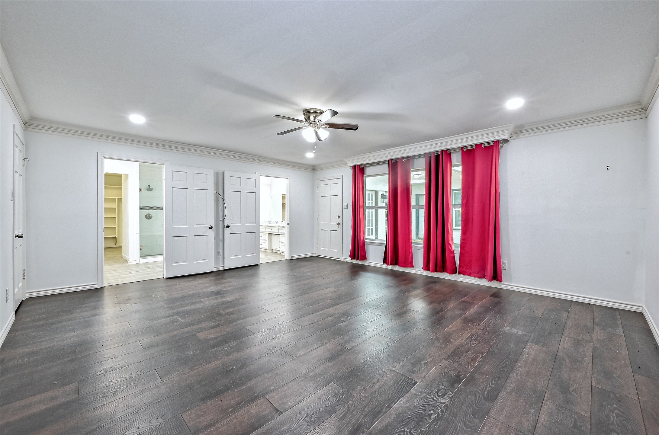 Primary bedroom with door to the back covered patio