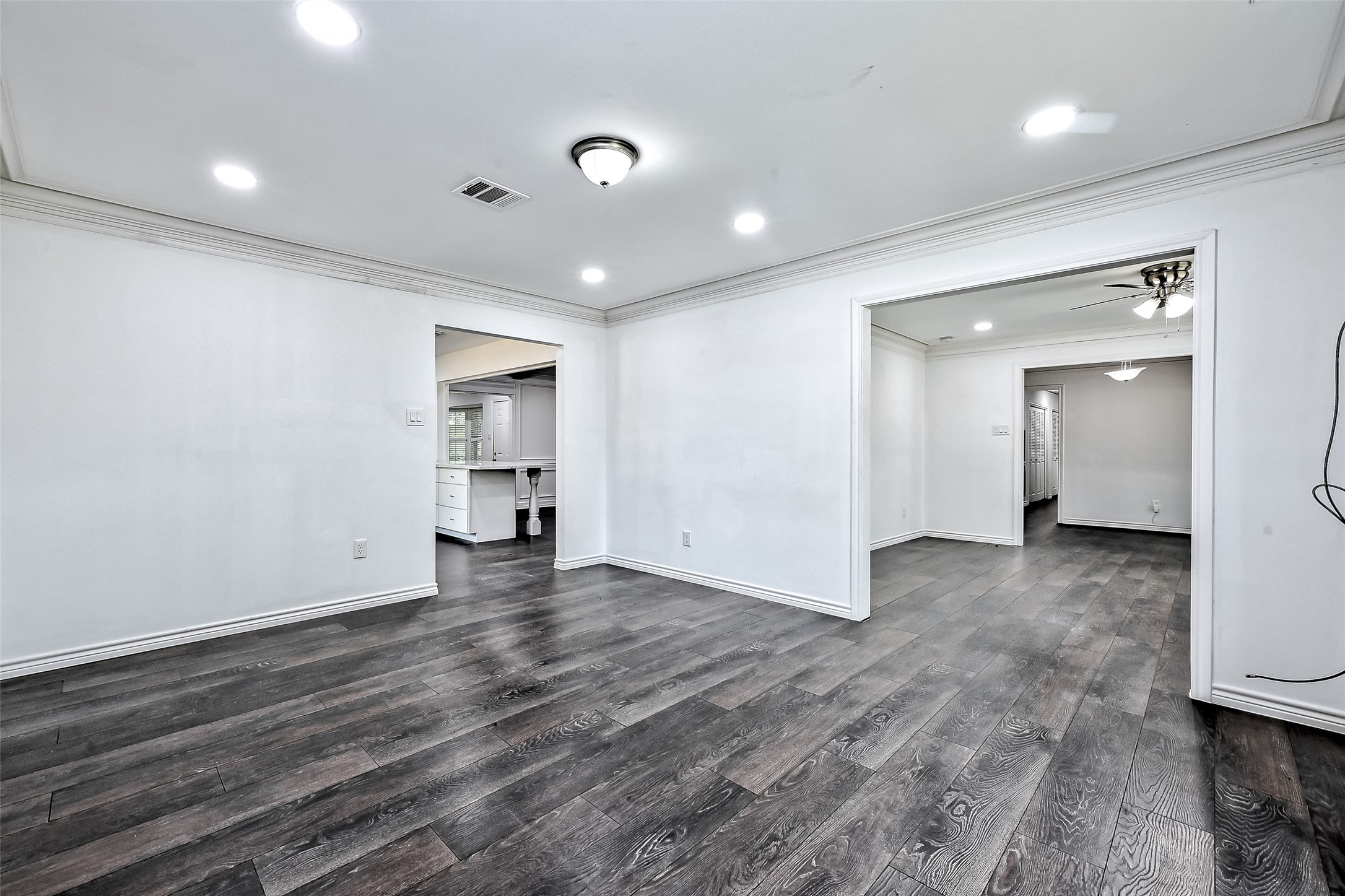 Dining room off the kitchen and next to living room is with many recess lights to make it so bright.