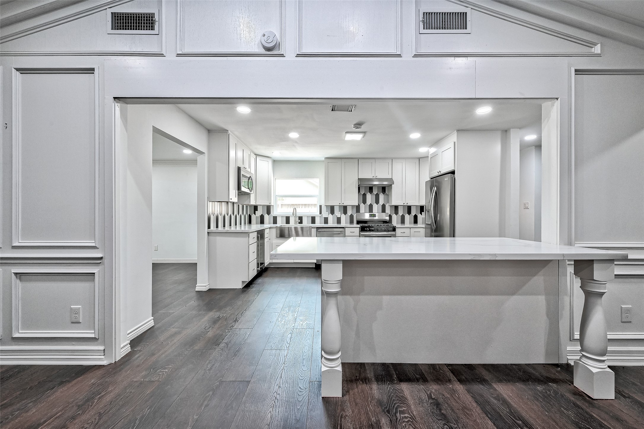Large island is between family room and kitchen