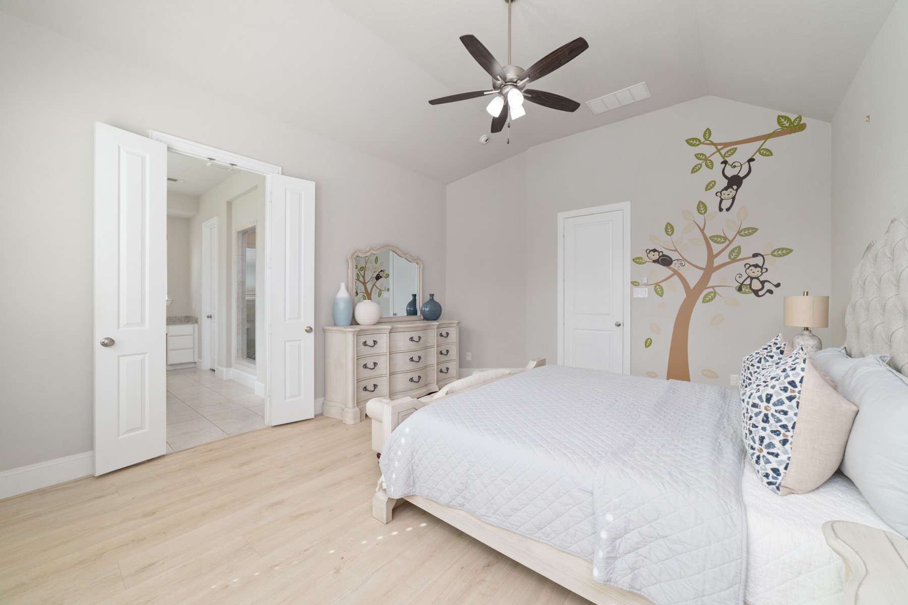 Bright and airy bedroom featuring light flooring.