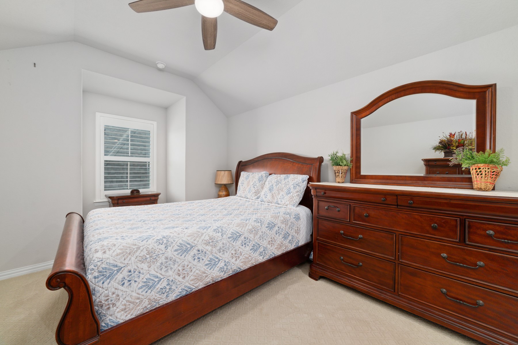 Cozy bedroom with modern ceiling fan.