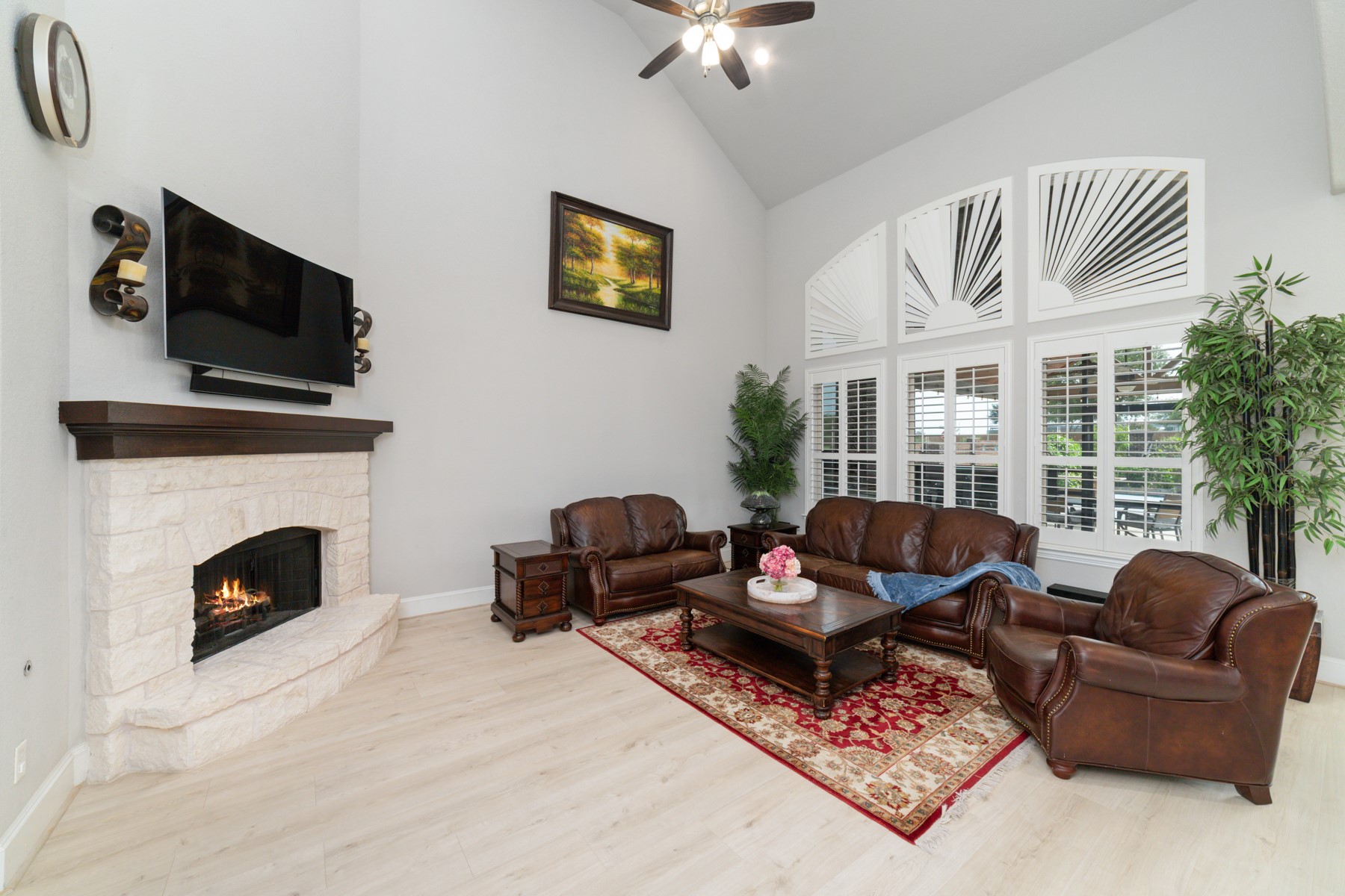 Spacious living room with high ceilings, and abundant natural light.