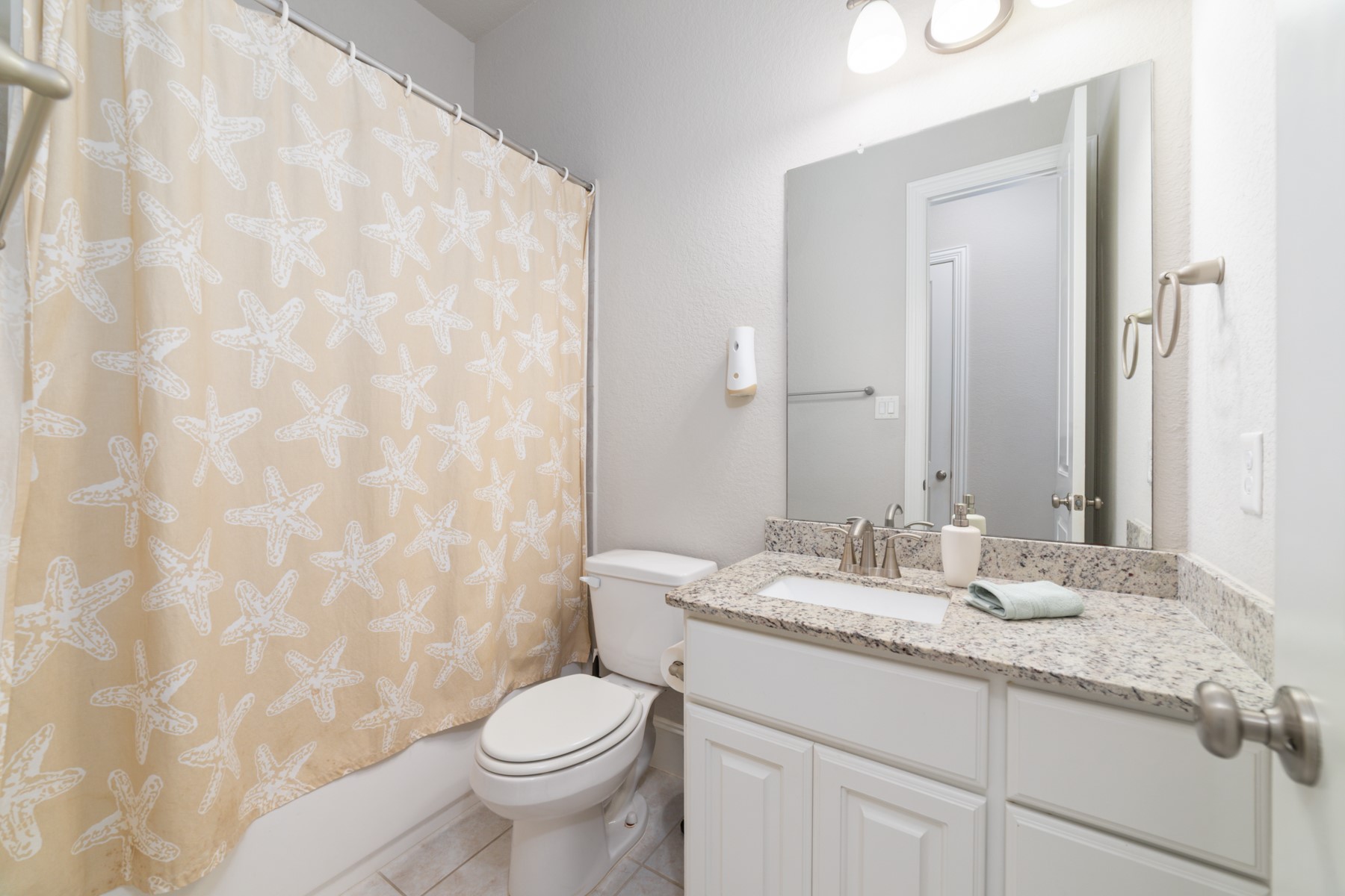 Charming bathroom with granite countertop.