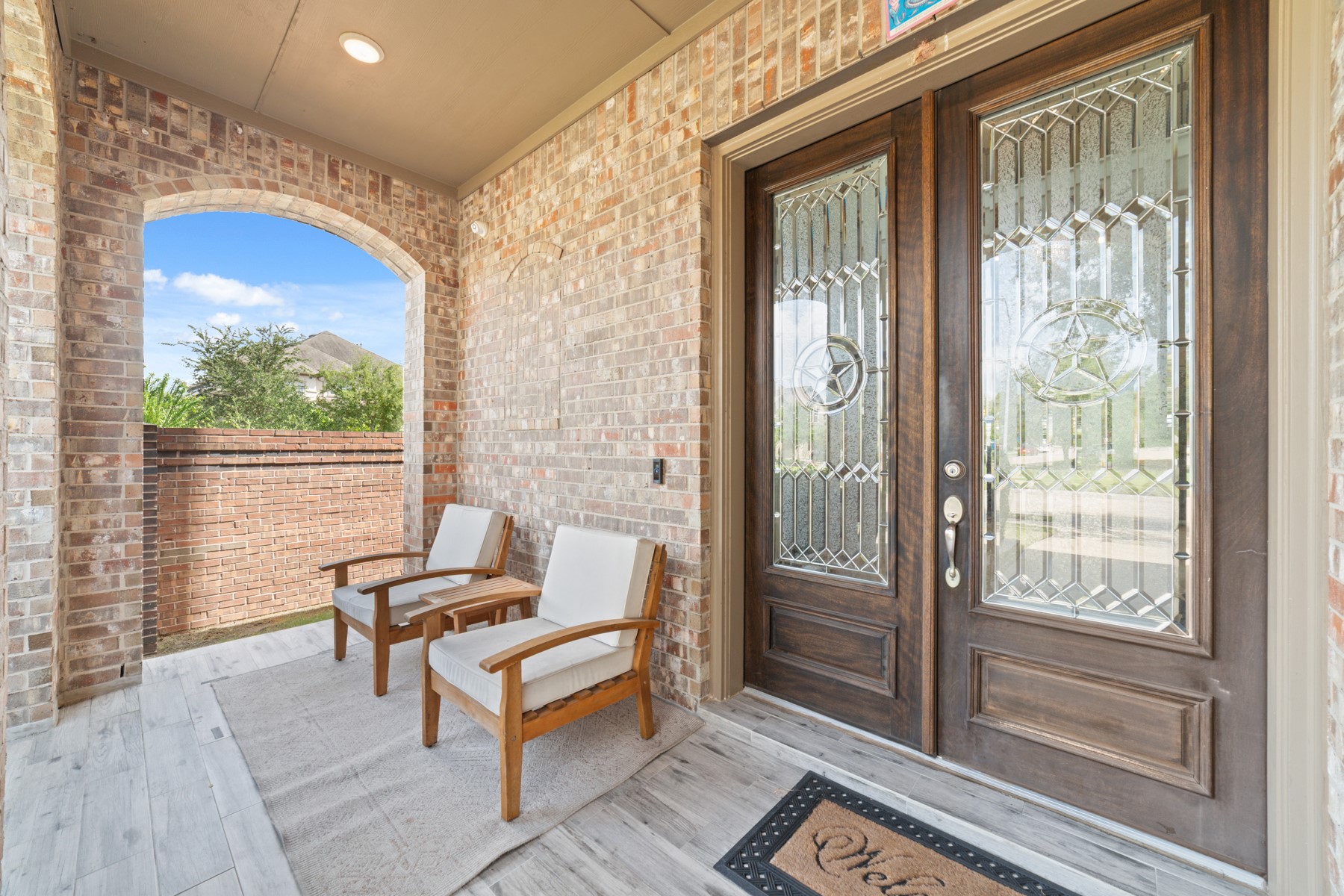Elegant double doors and cozy seating, perfect for relaxation.