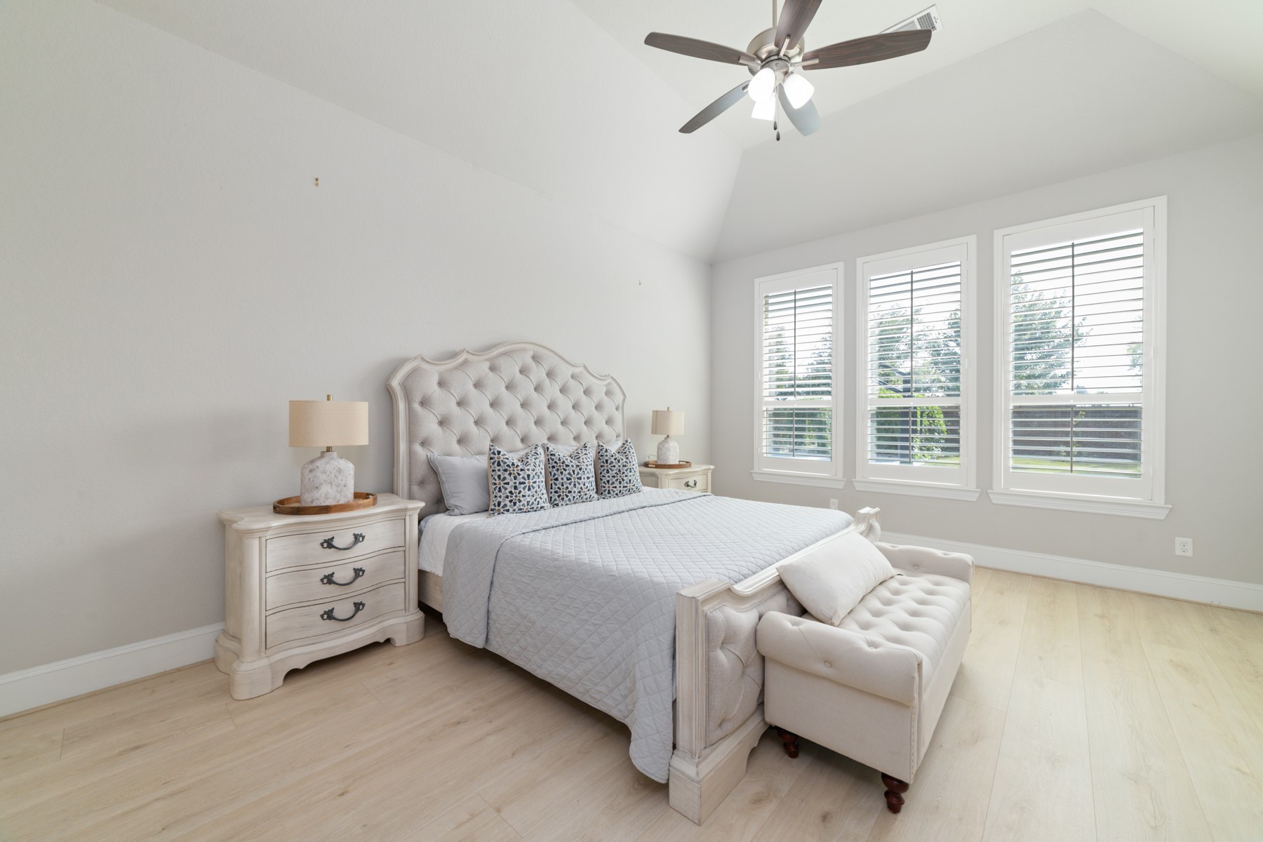 Spacious and serene bedroom featuring large windows that flood the space with natural light.