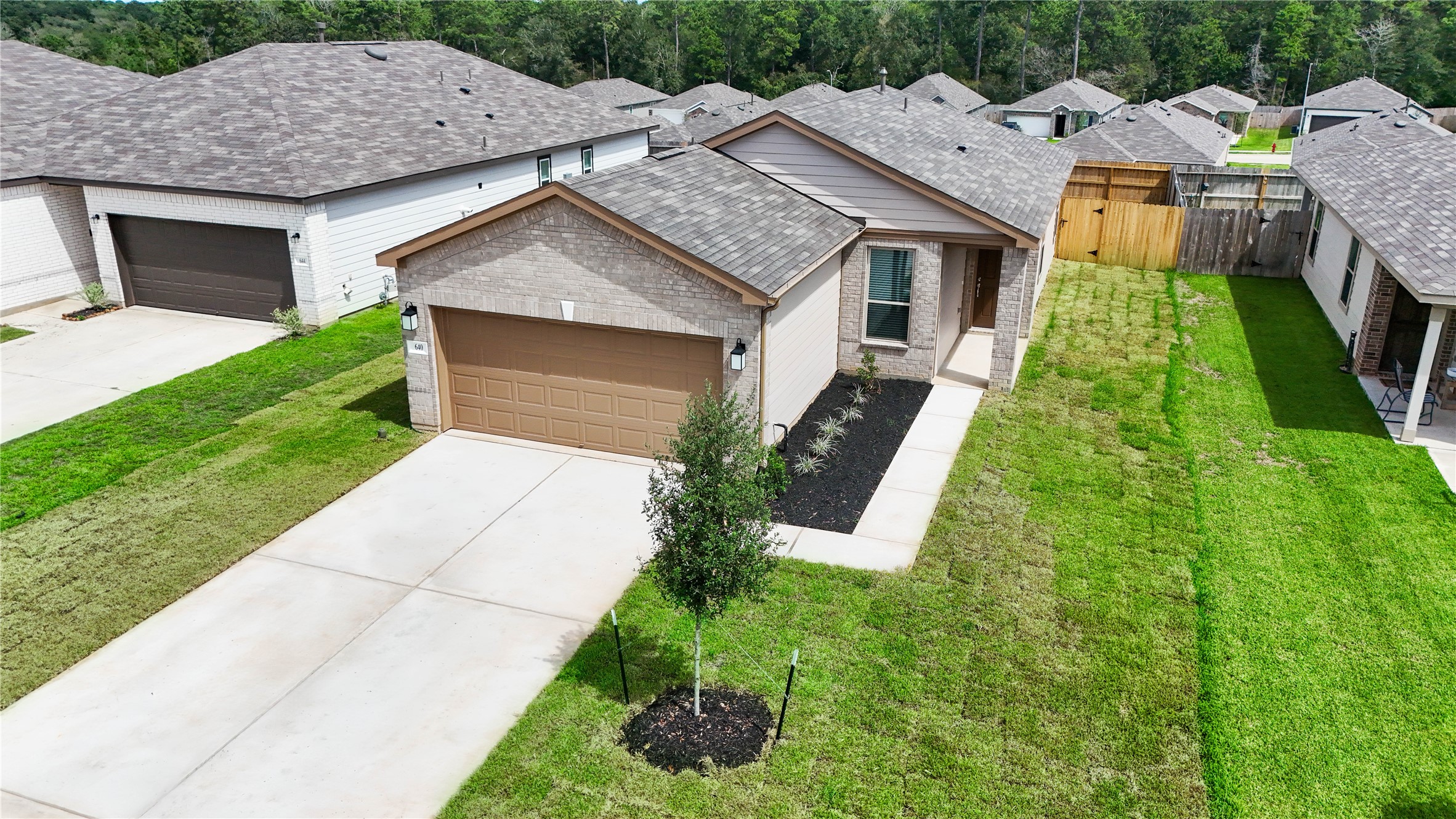 Additional aerial photo showcasing the spacious side yard.