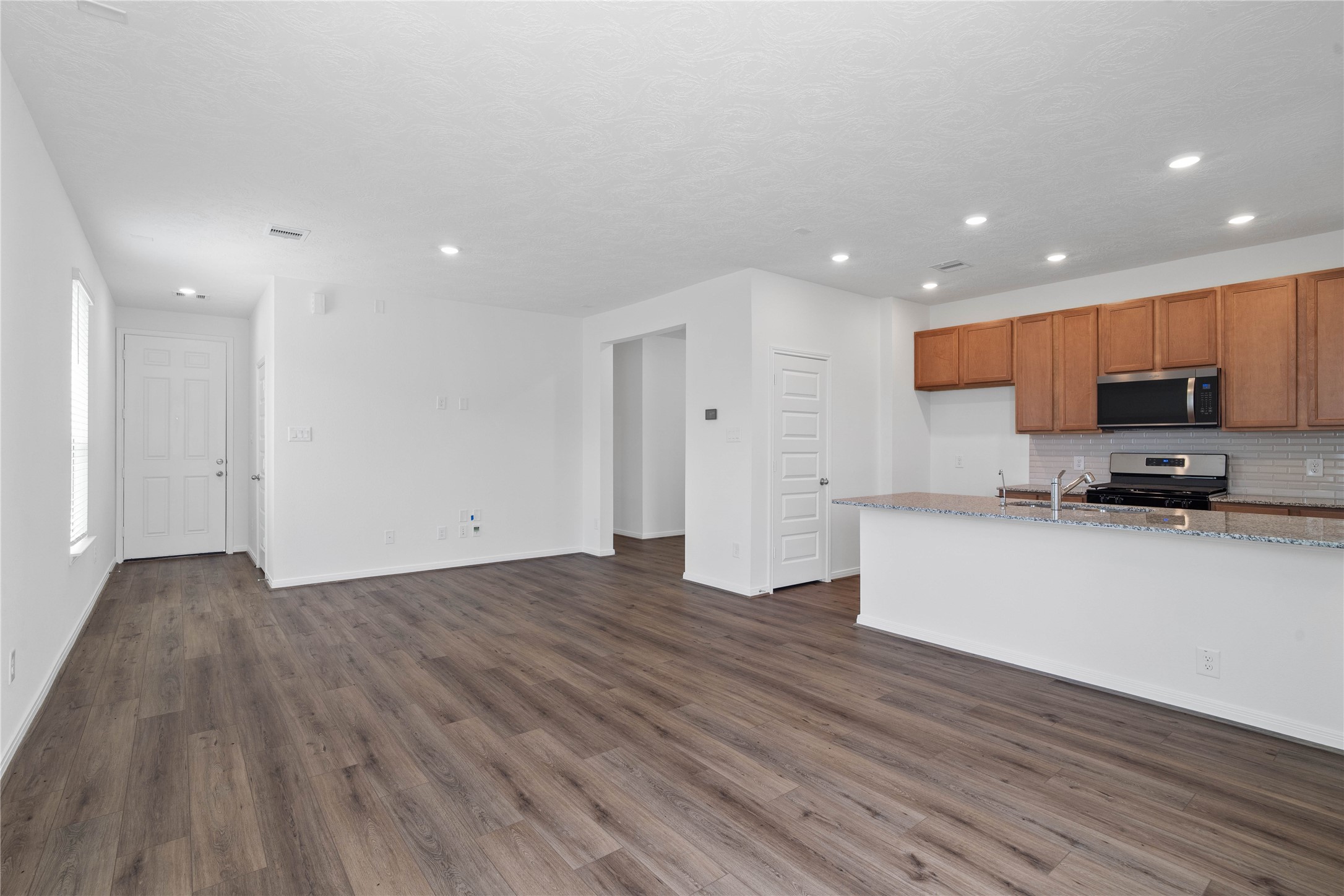 Bring family and friends together in this beautiful space! It features high ceilings, recessed lighting, custom paint, stunning and durable vinyl plank flooring, and large windows - which will fill the space with natural light all day long.