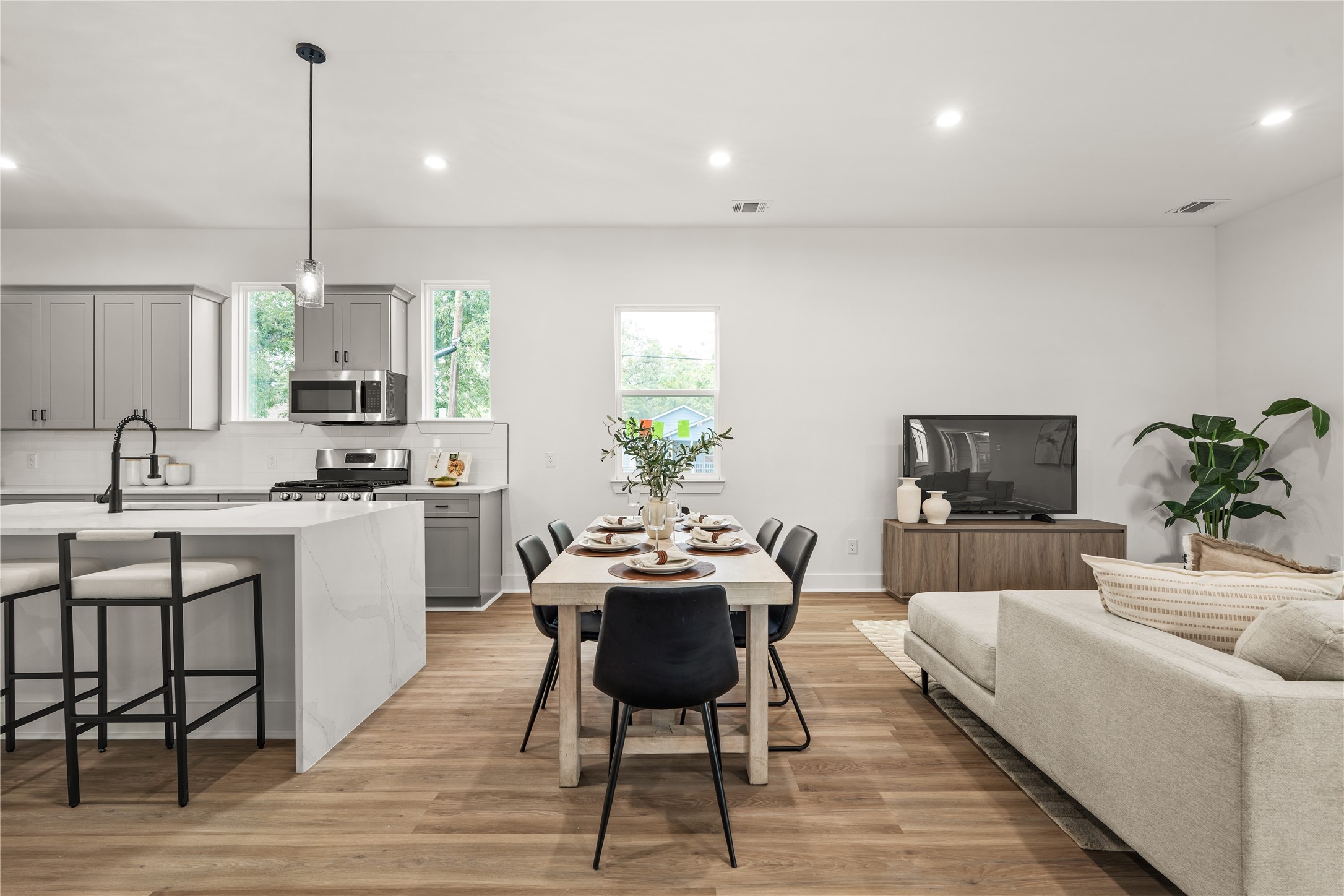 At the heart of the open plan, the dining area sits between the kitchen and living room, with a window
behind the table bringing natural light to every meal.