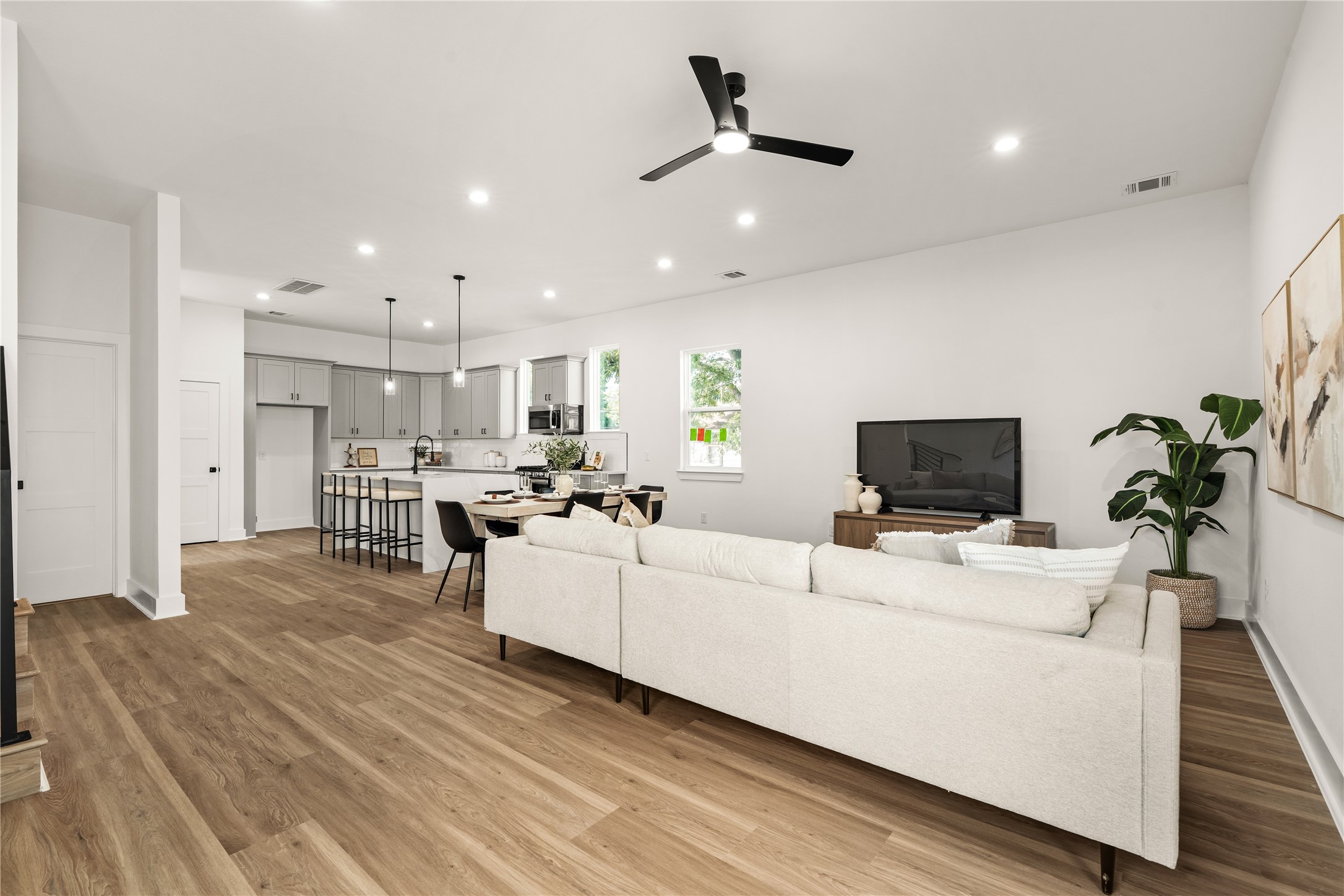 A sweeping view across the main level highlights the continuous flooring and open layout, so the living
room, dining area, and kitchen read as one cohesive, light-filled space.