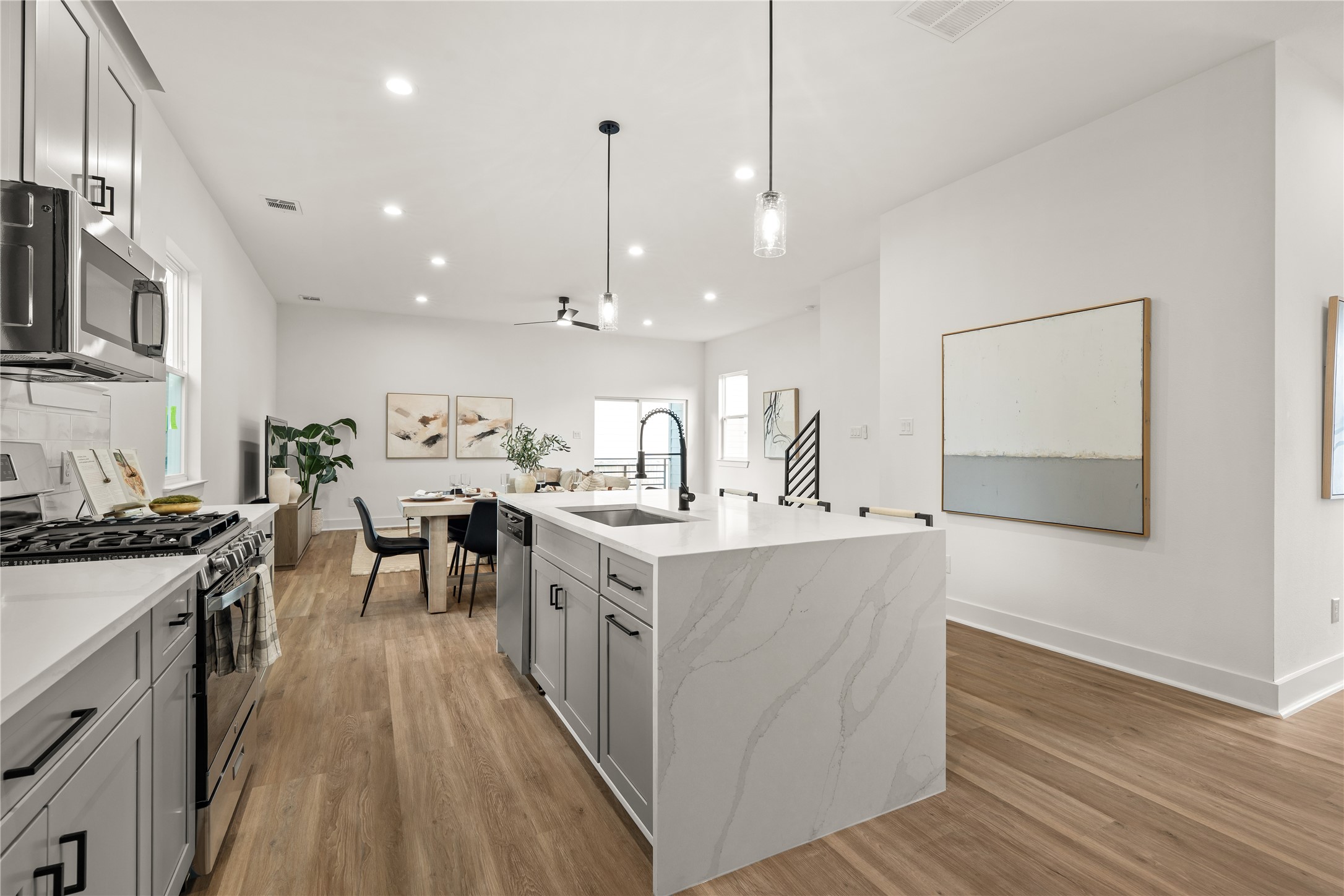 A closer view reveals the kitchen's working details, including stainless steel appliances, a glossy subway
tile backsplash, and generous drawer storage, all arranged in a layout that makes everyday cooking feel
effortless.