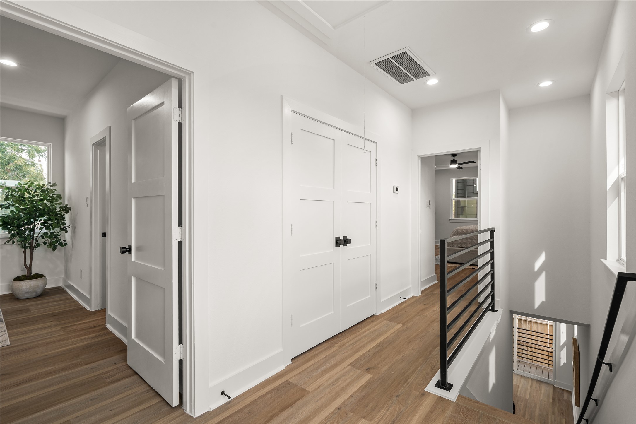 Upstairs, a bright landing connects the bedrooms, with the laundry room tucked behind double doors, a
modern black railing, and a stairwell window that fills the space with natural light.