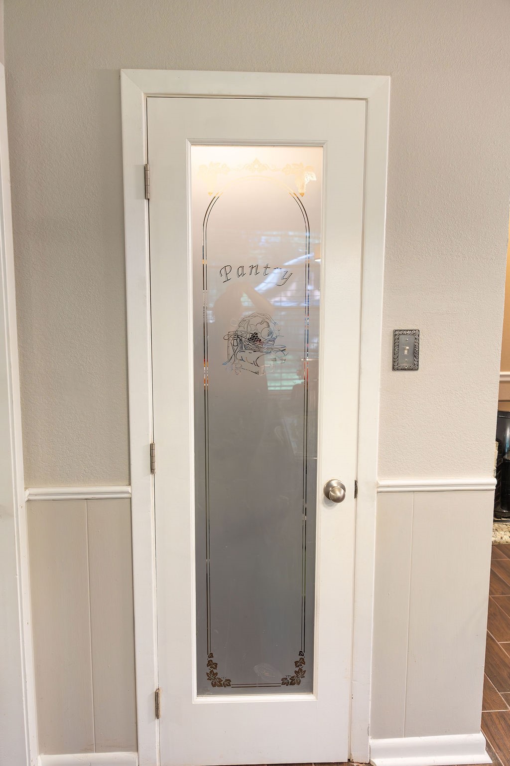 What a stylish touch! The frosted glass pantry door adds character and charm while offering a modern, elegant look that complements the kitchen beautifully.