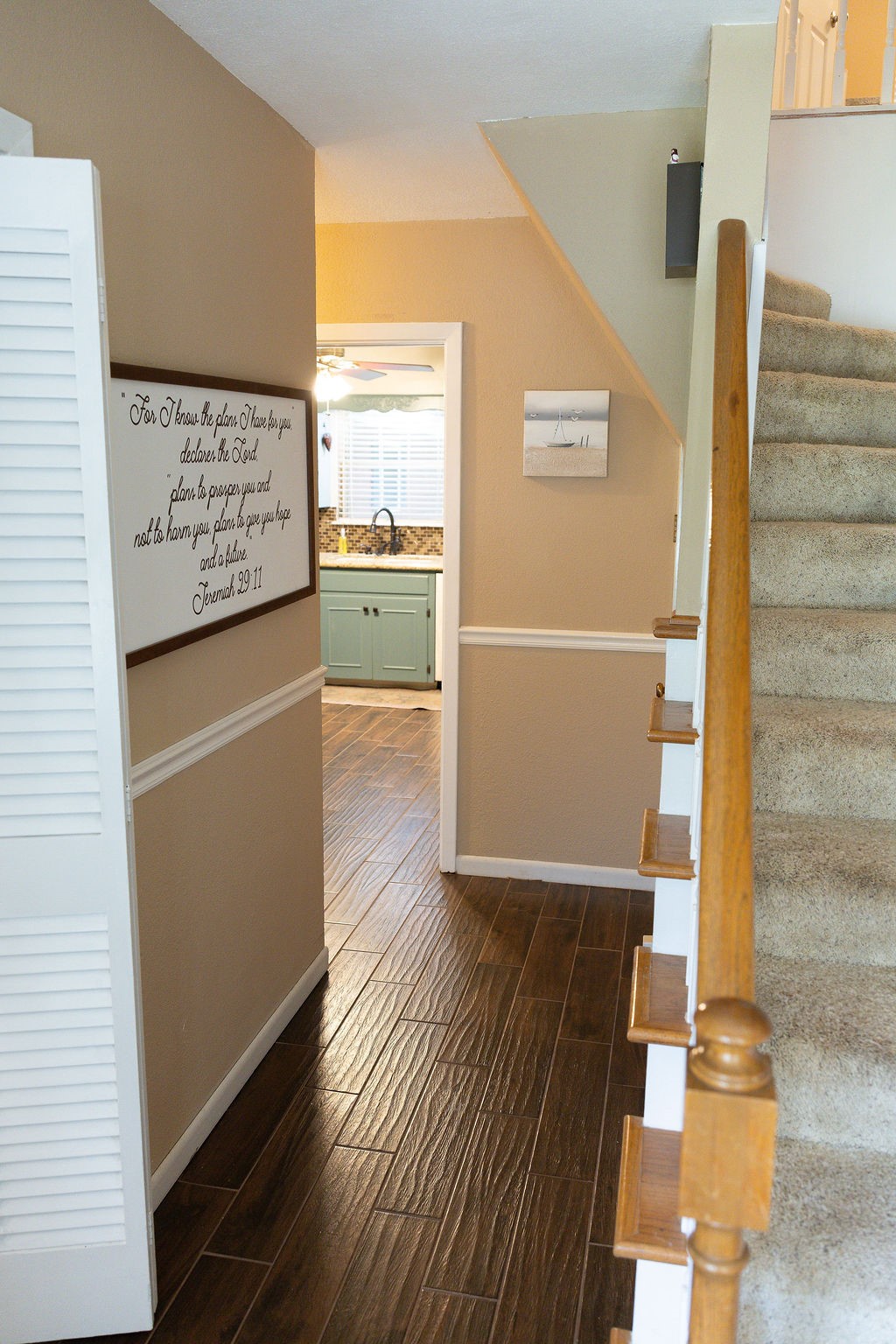 Step into a beautiful entryway that showcases the elegant spindle staircase and welcomes you with an open, inviting layout. From the foyer, you'll enjoy views into the kitchen, family room, and a gorgeous private study, creating a warm and impressive first impression.