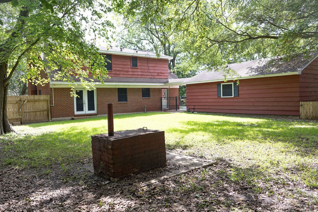Take a look at this spacious, fenced backyard! With plenty of room to relax, play, or entertain, it's a space the whole family can enjoy. The custom brick smoker is the perfect finishing touch, ready for backyard barbecues, holiday cookouts, and making memories with family and friends.